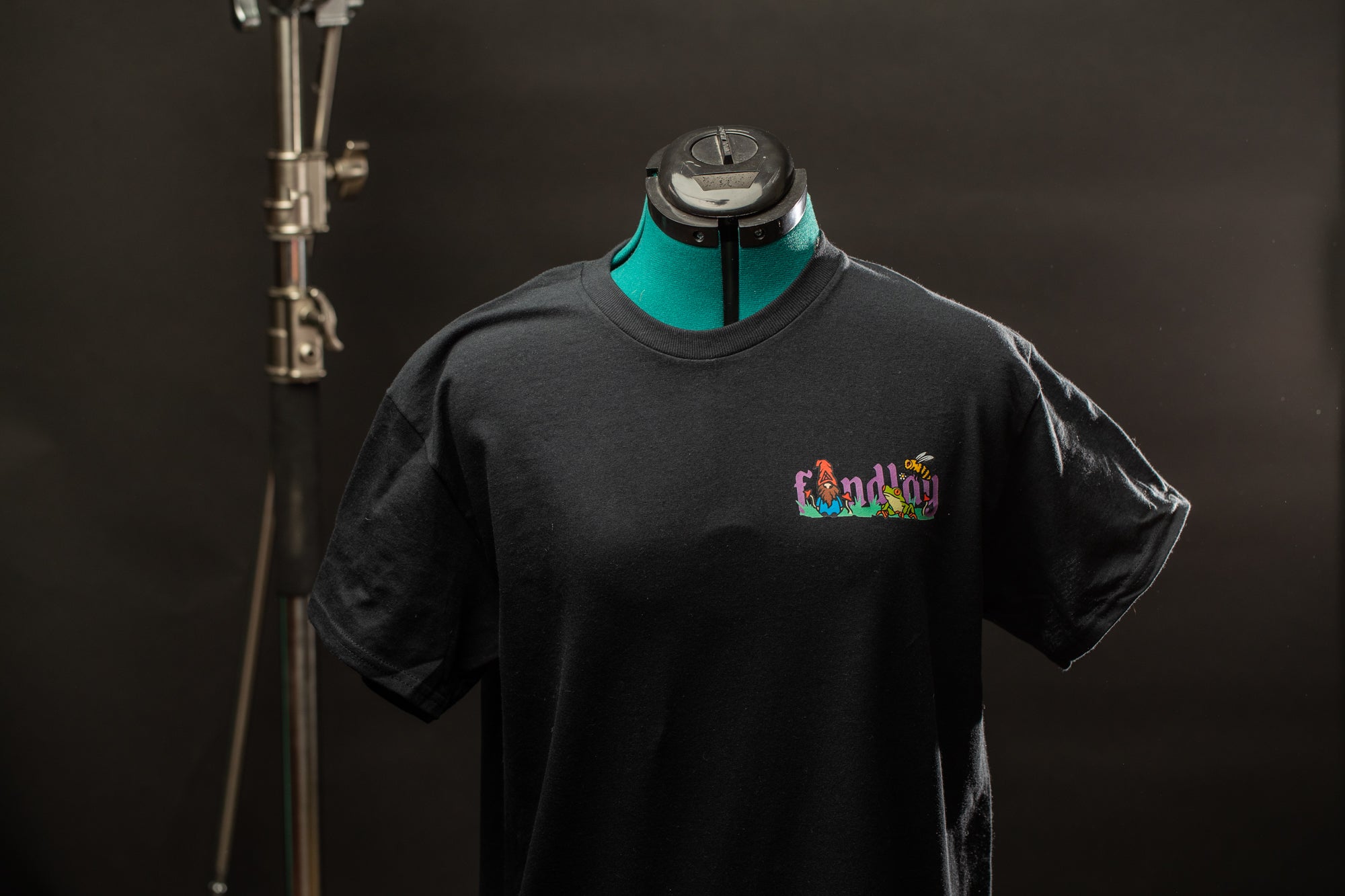 a black shirt with a green collar and a microphone