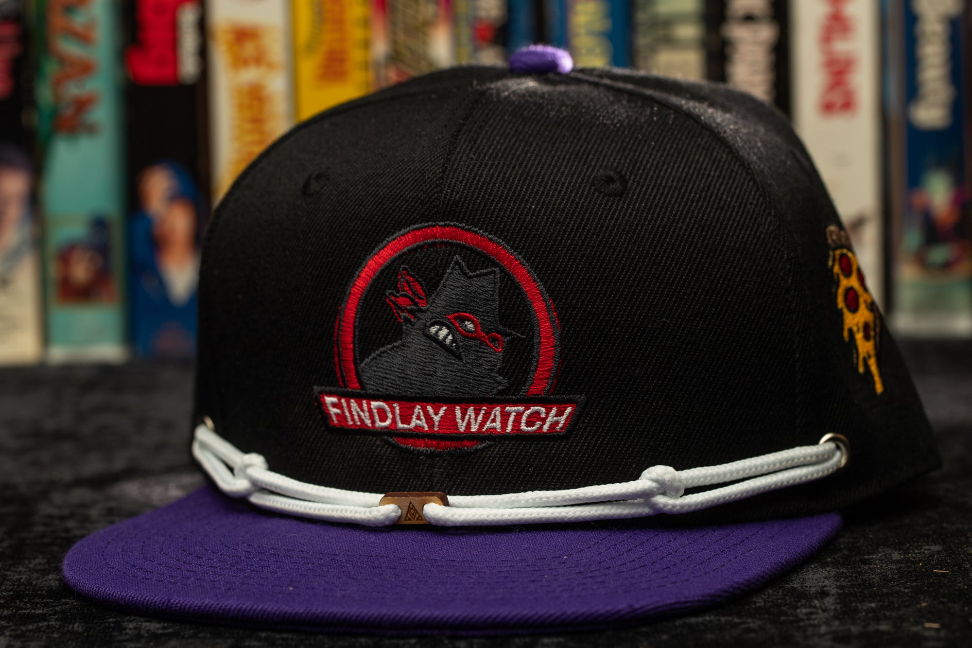 a black and purple hat sitting on top of a table