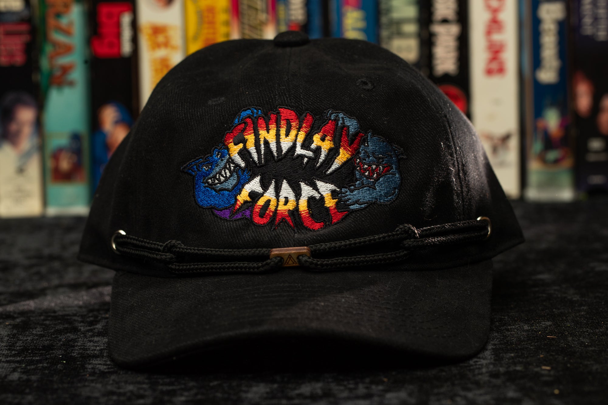 a black hat with a comic logo on it