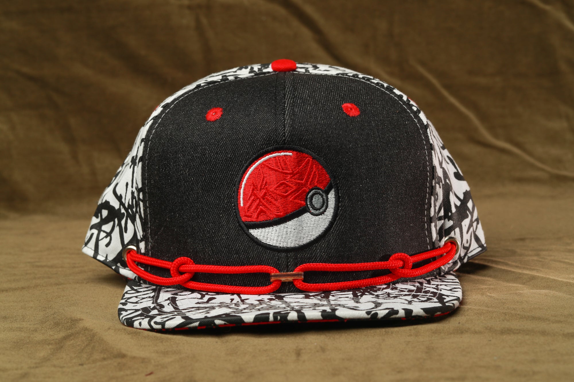 A black and white baseball cap with a red Pokemon logo on the front.