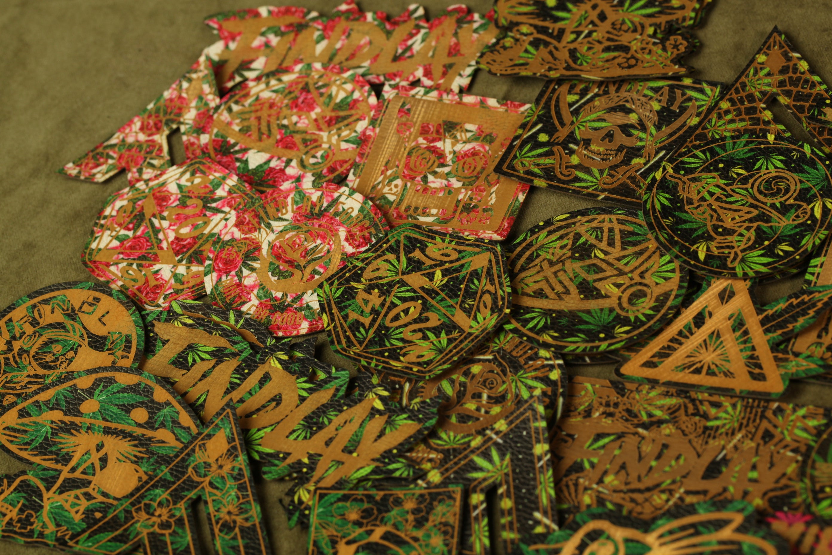 a collection of various printed and cut-out shapes, including floral patterns, geometric designs, and text. The shapes are arranged in a visually interesting manner, with some overlapping each other and others placed in a pile. The image does not contain any text, and the descriptions provided are not too specific or detailed.