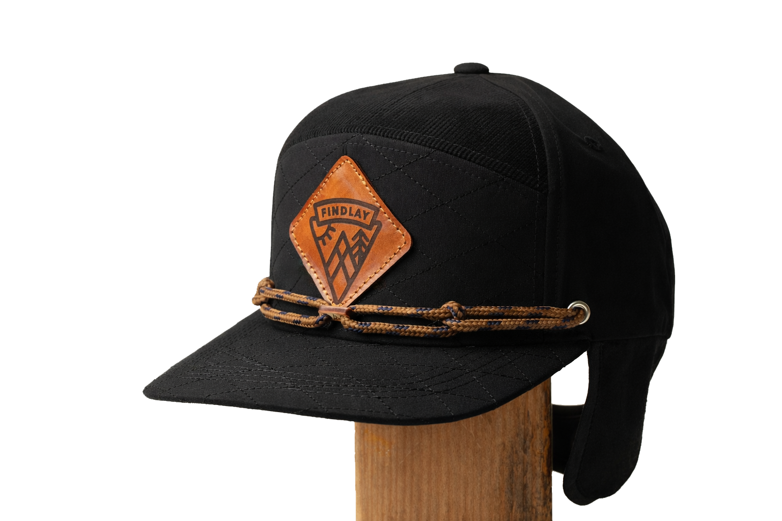 A black baseball cap with a leather patch and a rope strap.