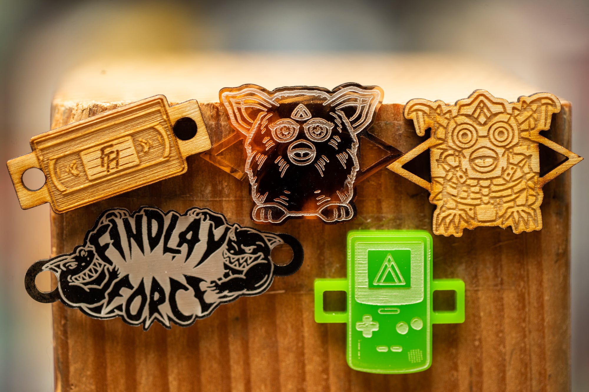 a bunch of badges that are on a wooden board