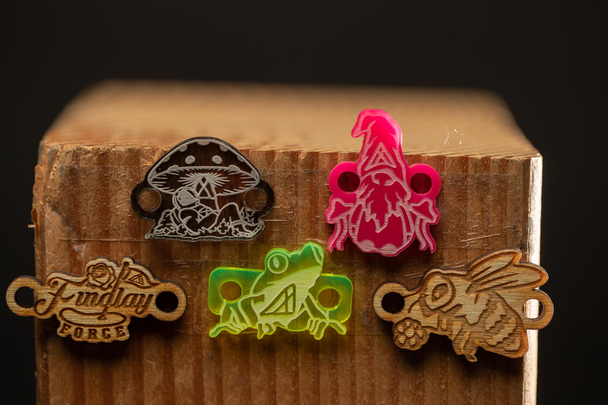 a group of wooden charms sitting on top of a wooden box