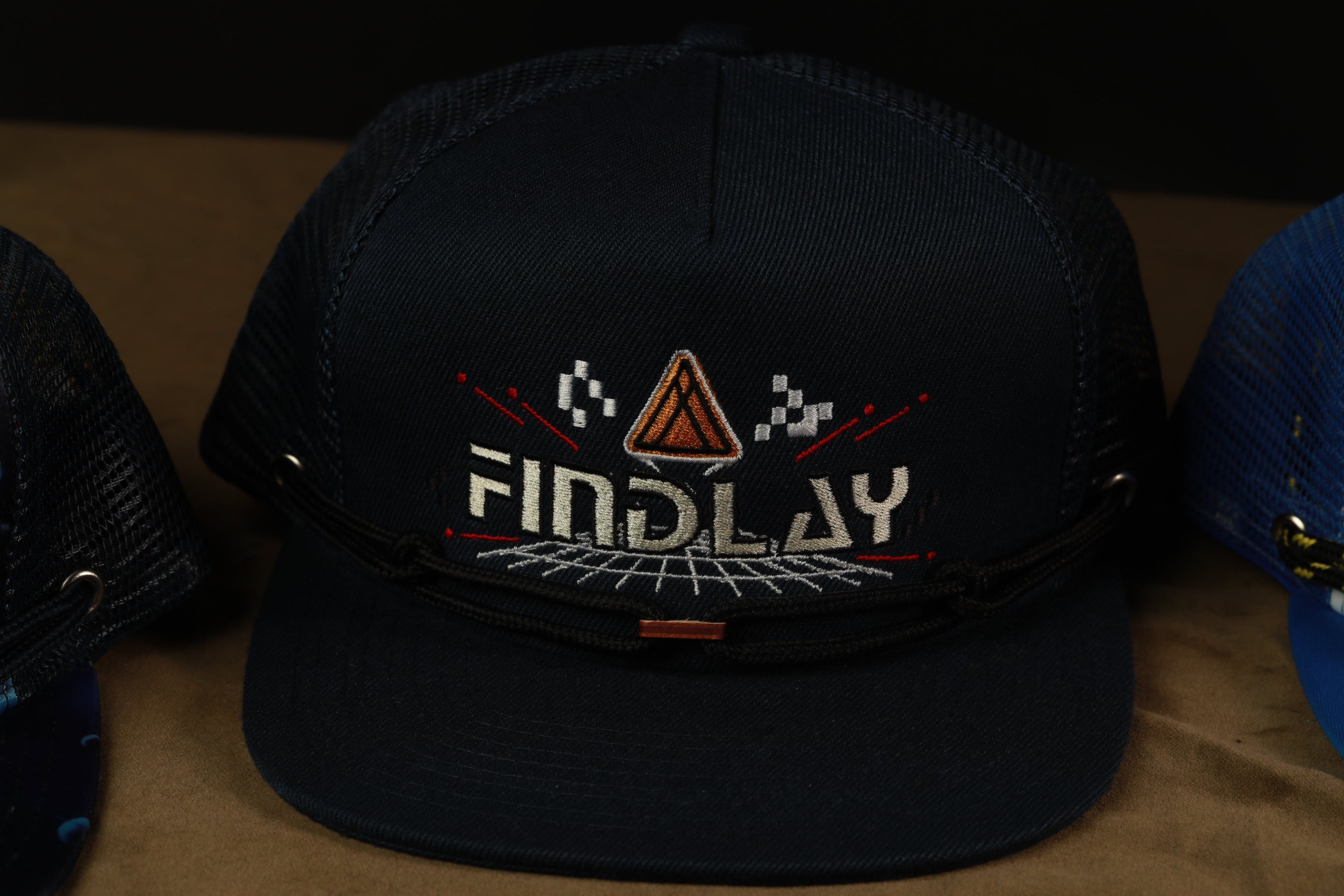 A black baseball cap with the word "FINDlay" embroidered on it.