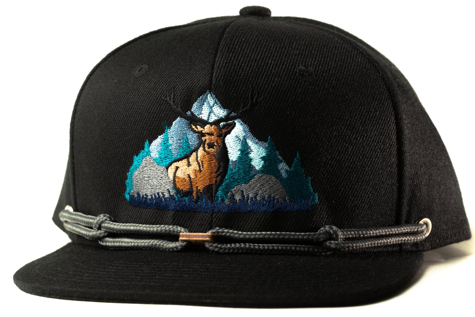 A black baseball cap with a graphic of a deer standing in front of a mountain landscape.