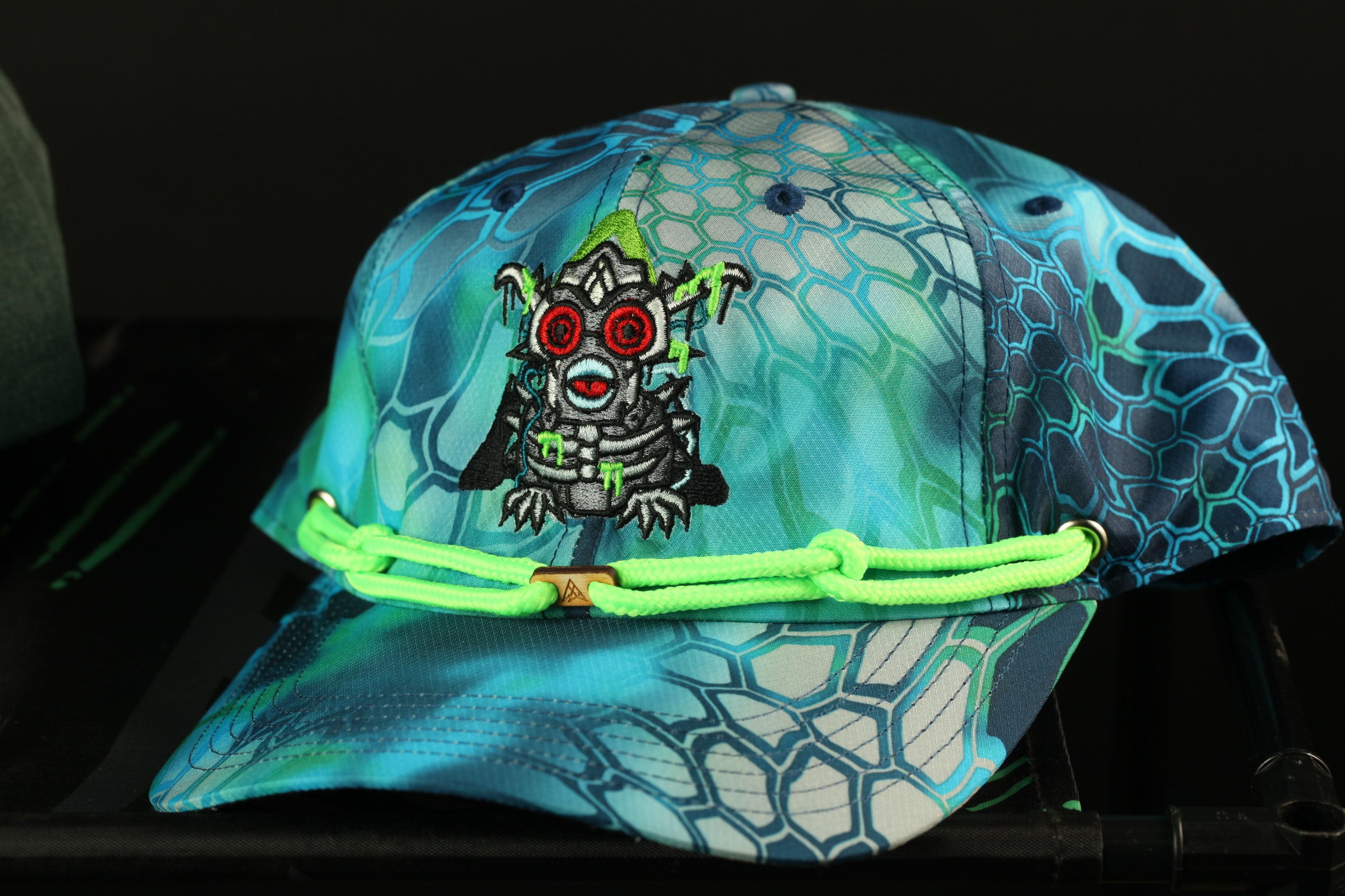 A colorful, patterned baseball cap with a unique design featuring a cartoon-like character.
