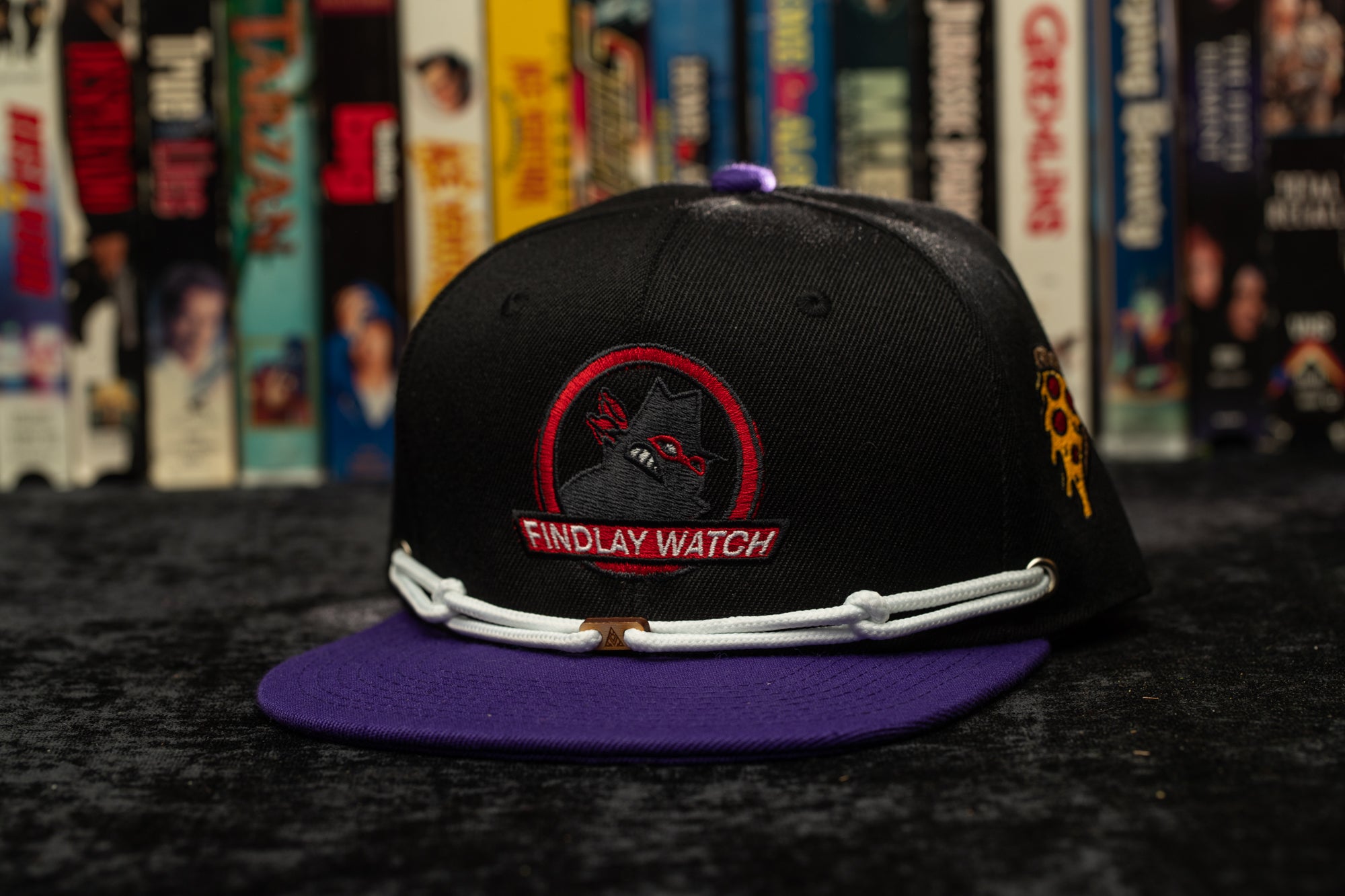 a black and purple hat sitting on top of a table