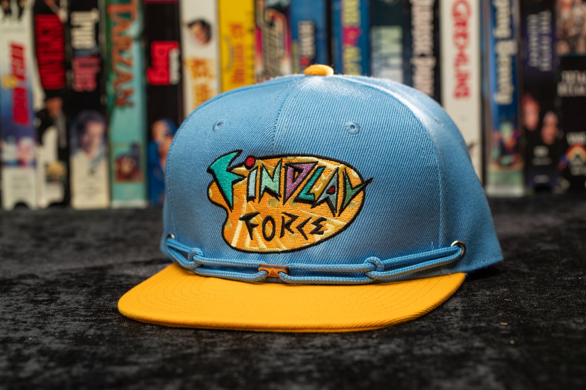 a blue and yellow hat sitting on top of a table