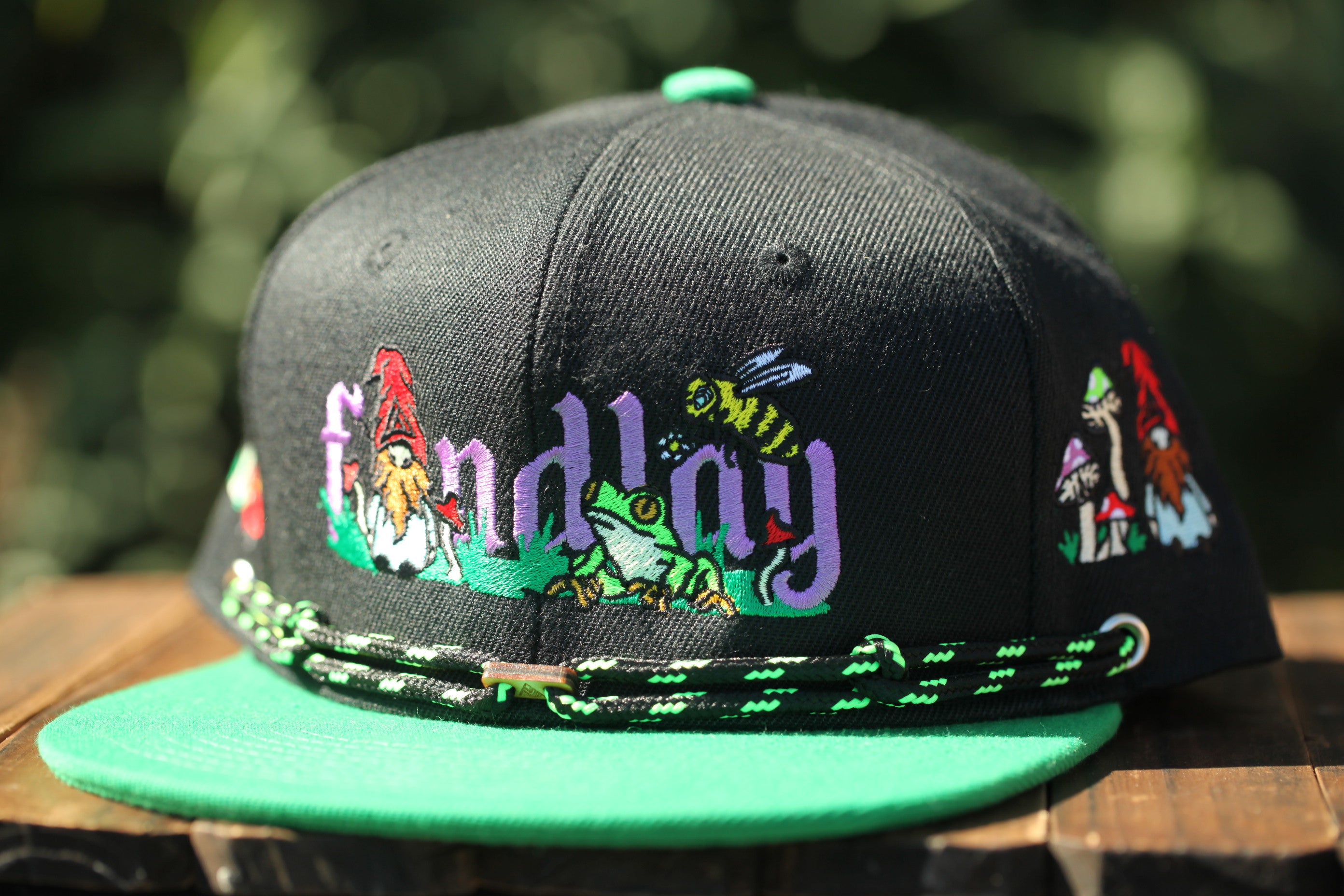 A black baseball cap with colorful embroidered designs and the word "Findlay" printed on it.