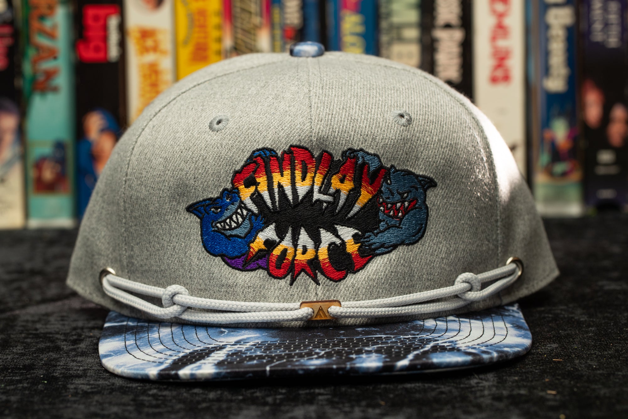 a gray and blue hat with a cartoon bear on it