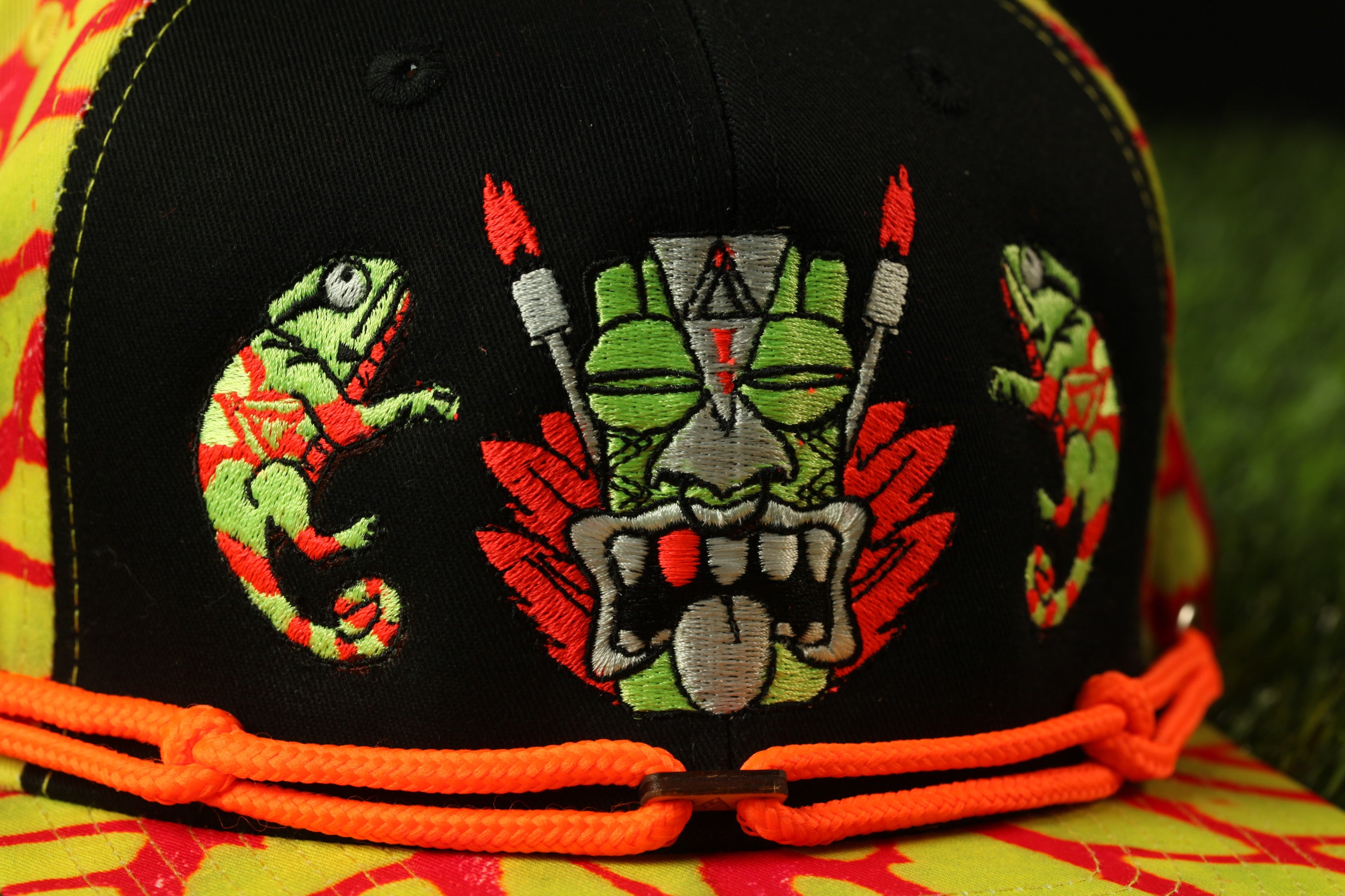 a close-up view of a baseball cap with a colorful, embroidered design on the front.