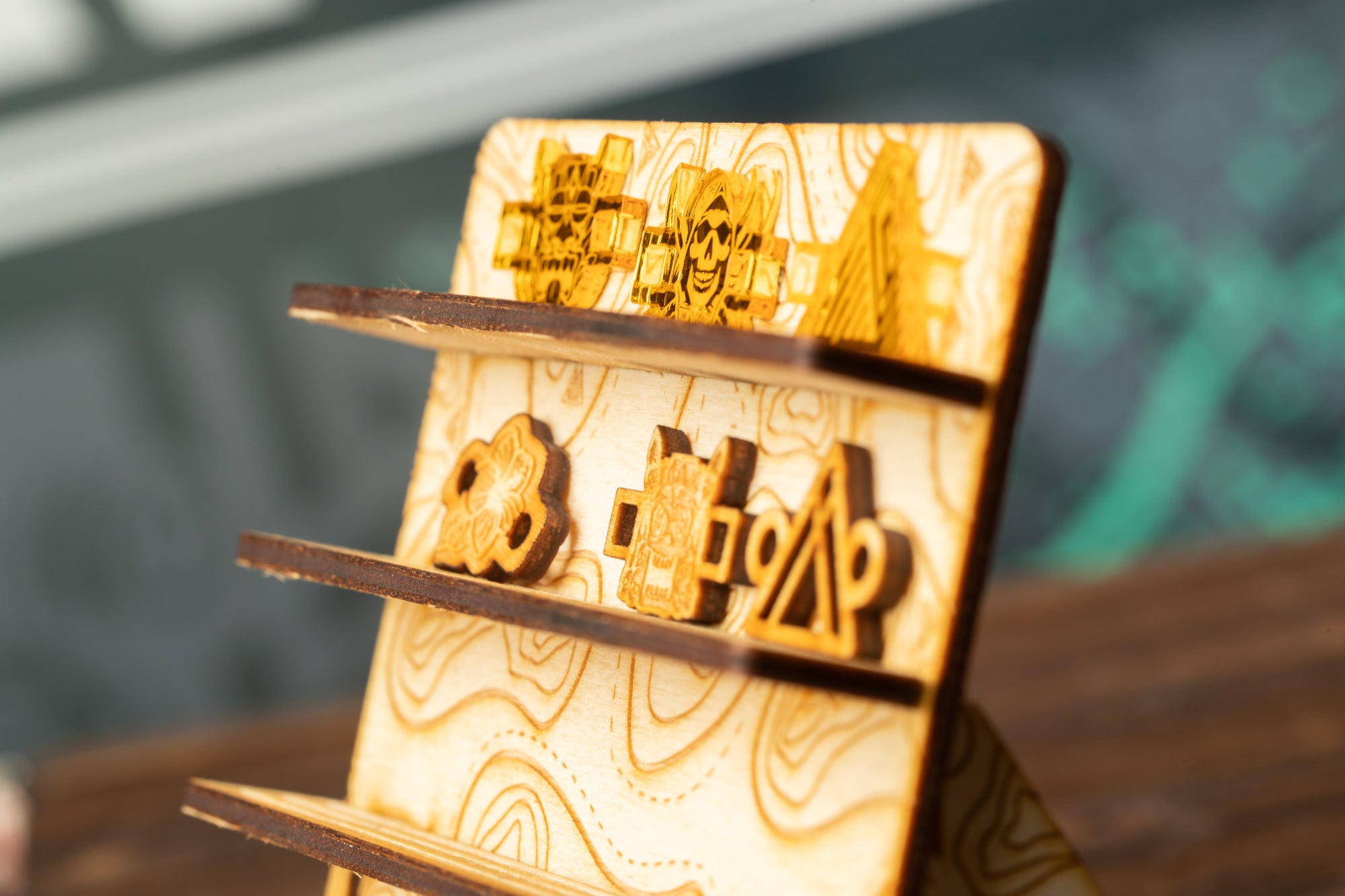 A wooden display with various shapes and symbols engraved on it, including a skull, a triangle, and a flower.
