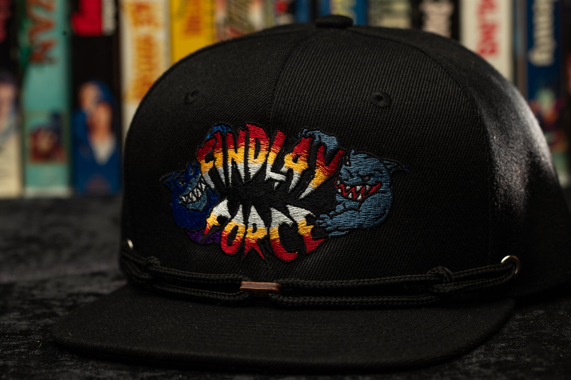 a black hat with a picture of a dinosaur on it