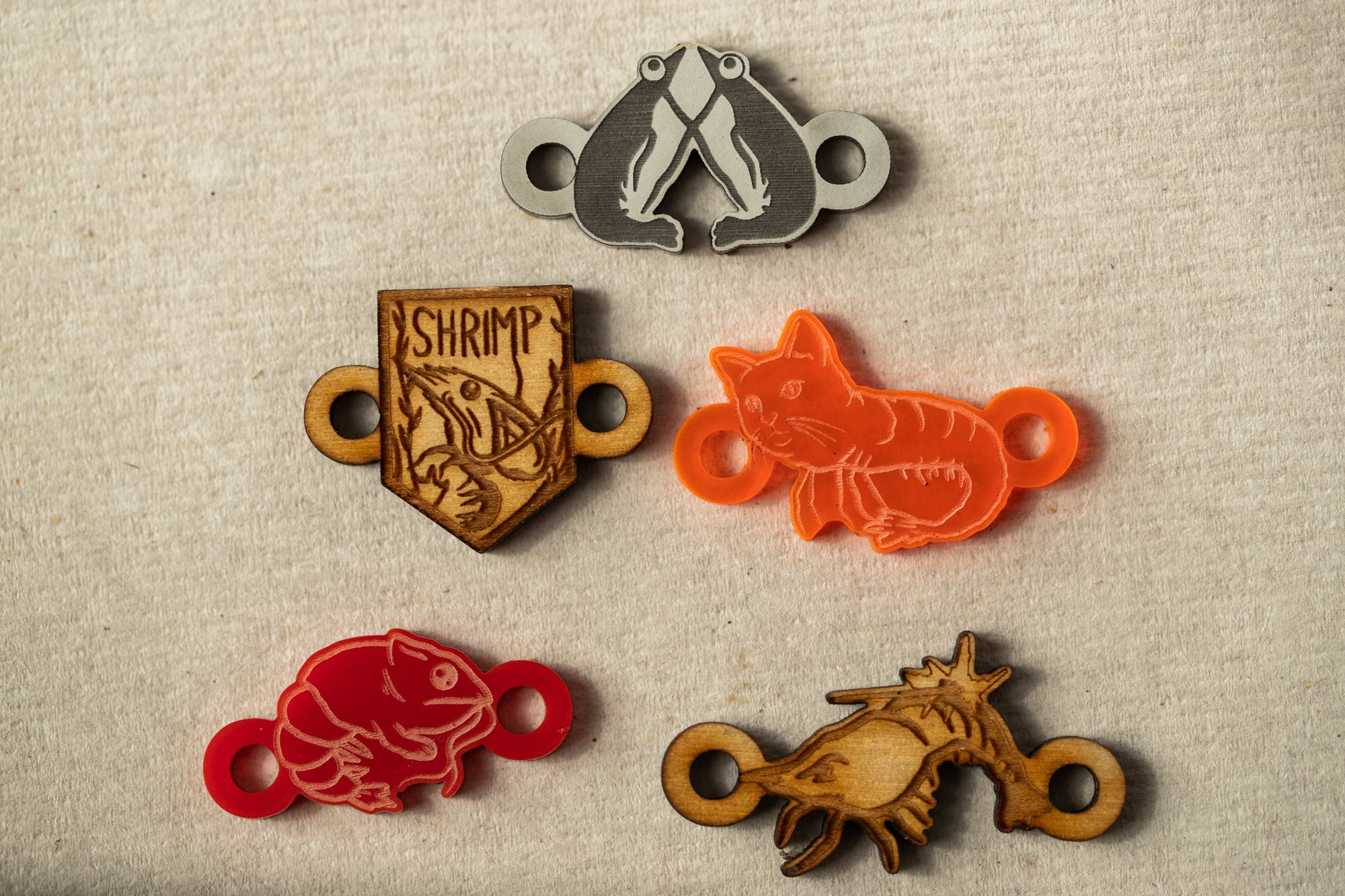 a group of four different colored wooden badges
