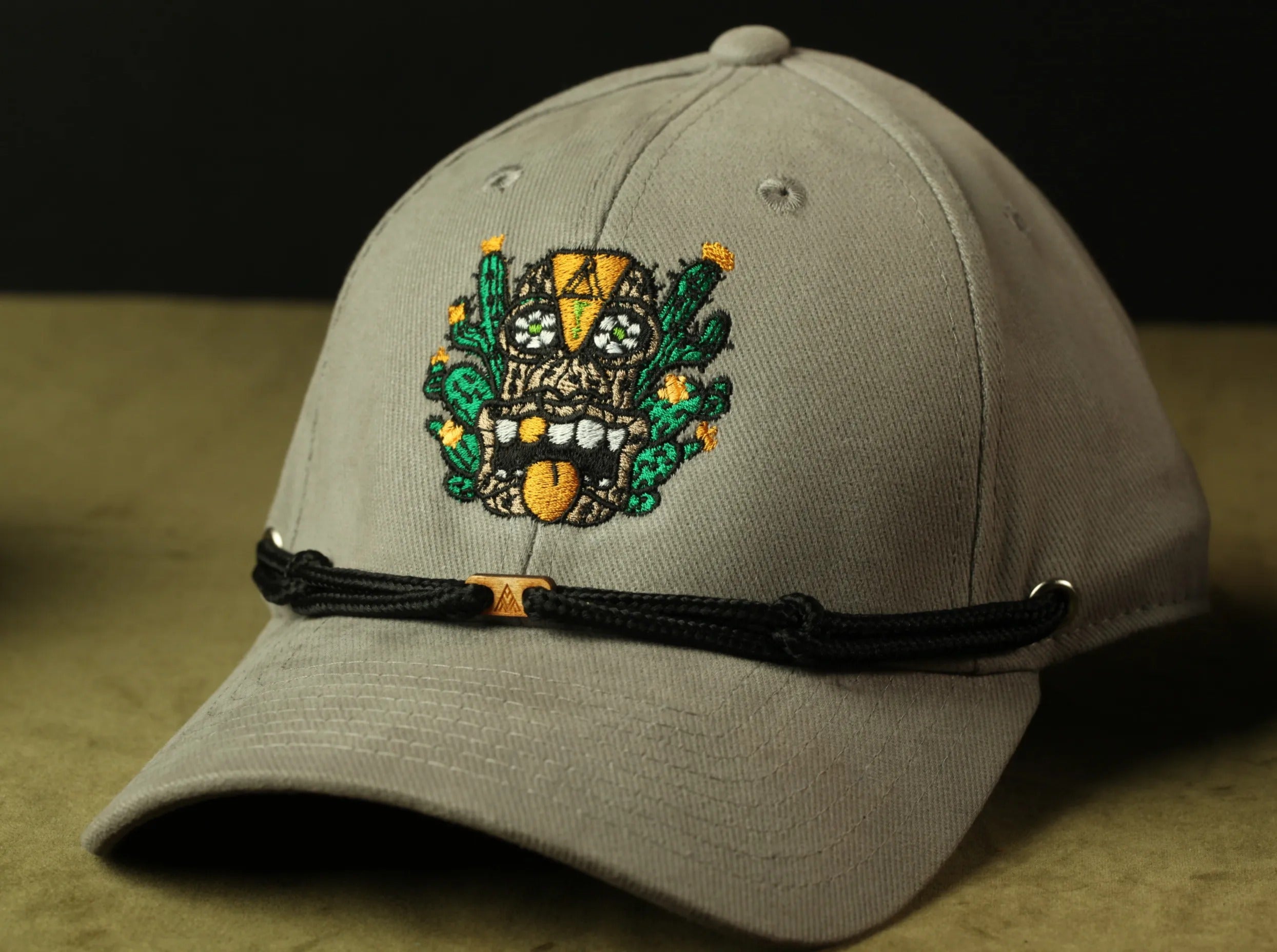 A gray baseball cap with a colorful embroidered design on the front.