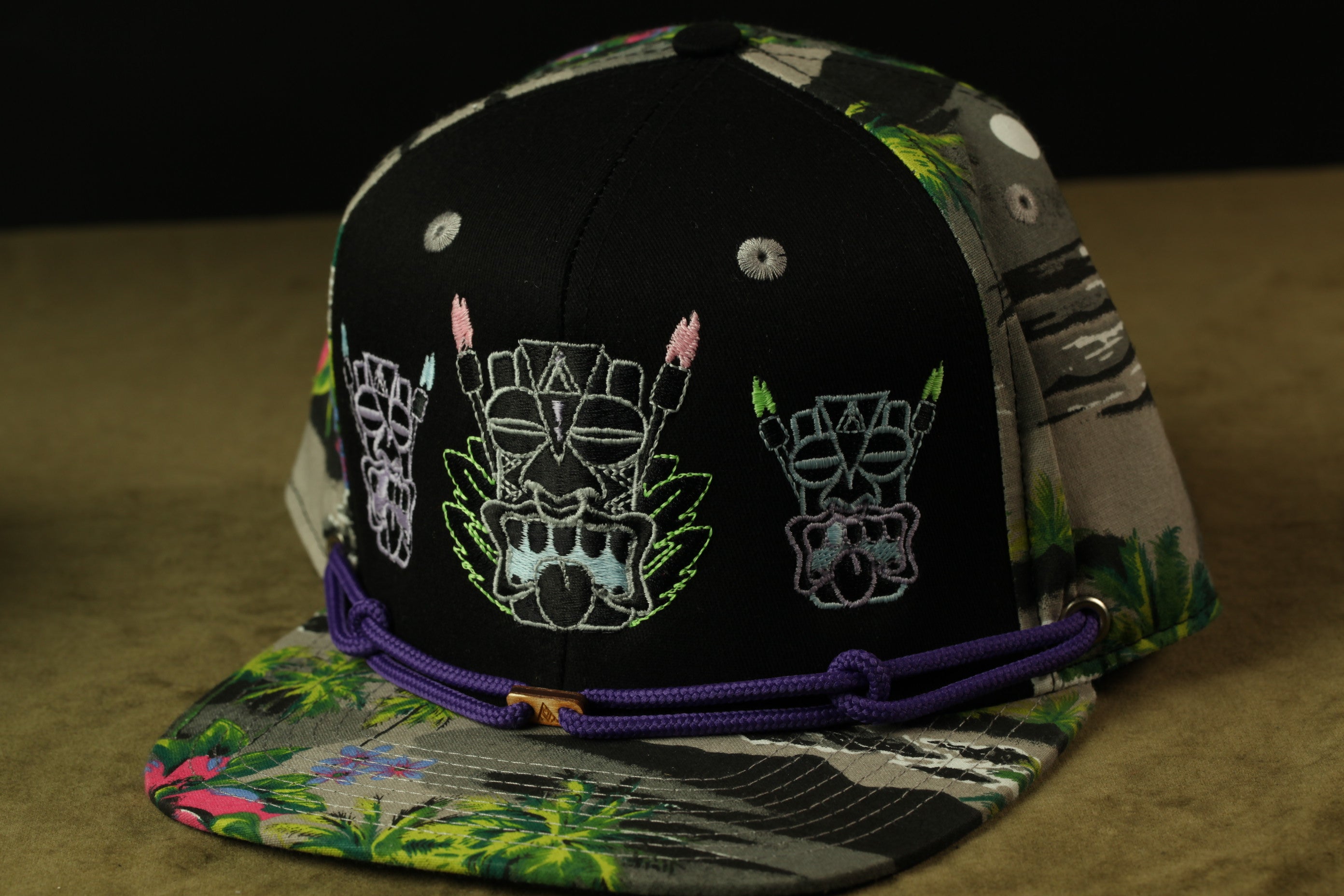 A colorful baseball cap with a black brim and a patterned fabric.
