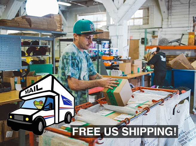 a man standing in a warehouse with boxes and a truck