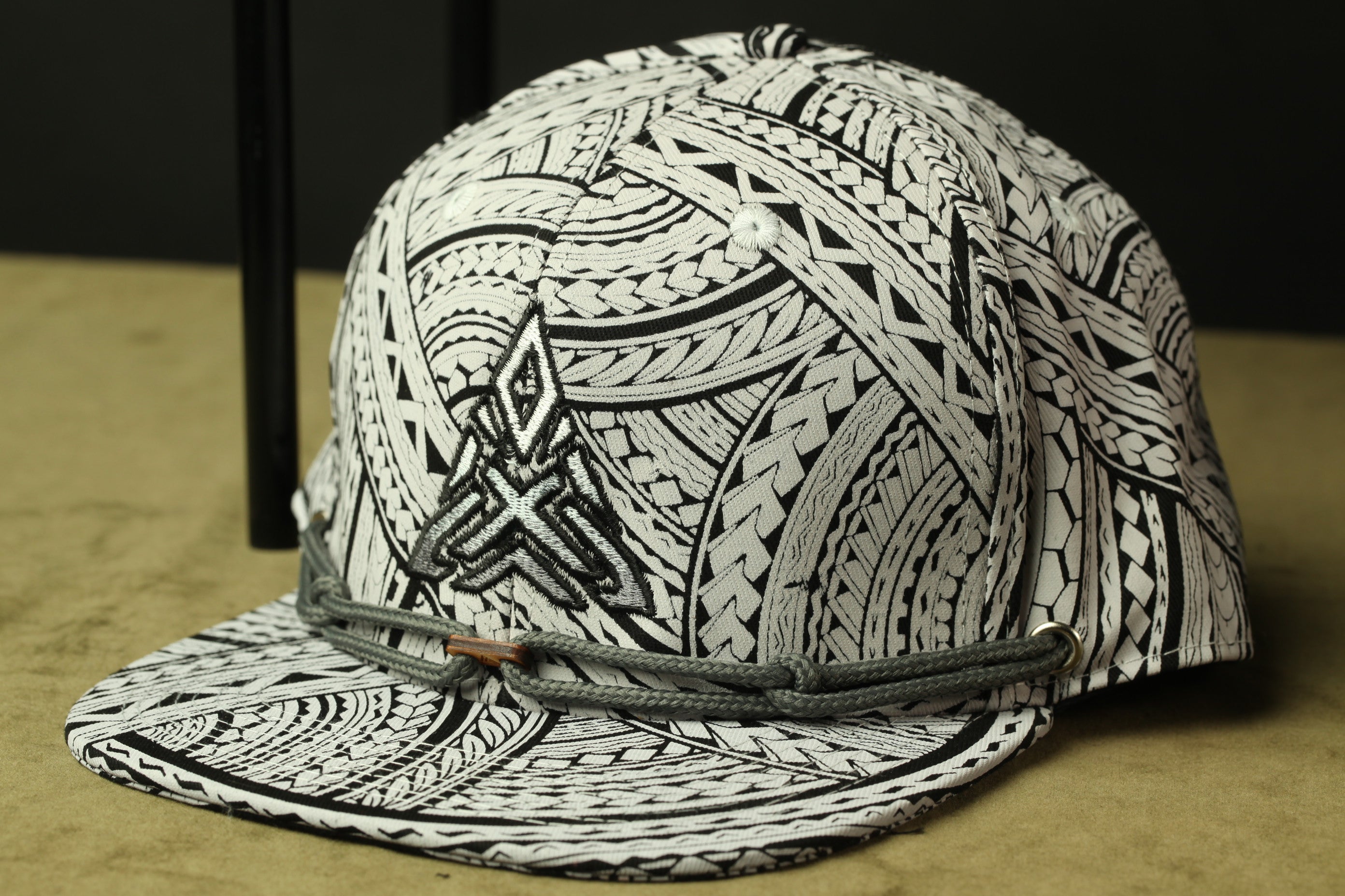 A black and white patterned baseball cap with a geometric design.