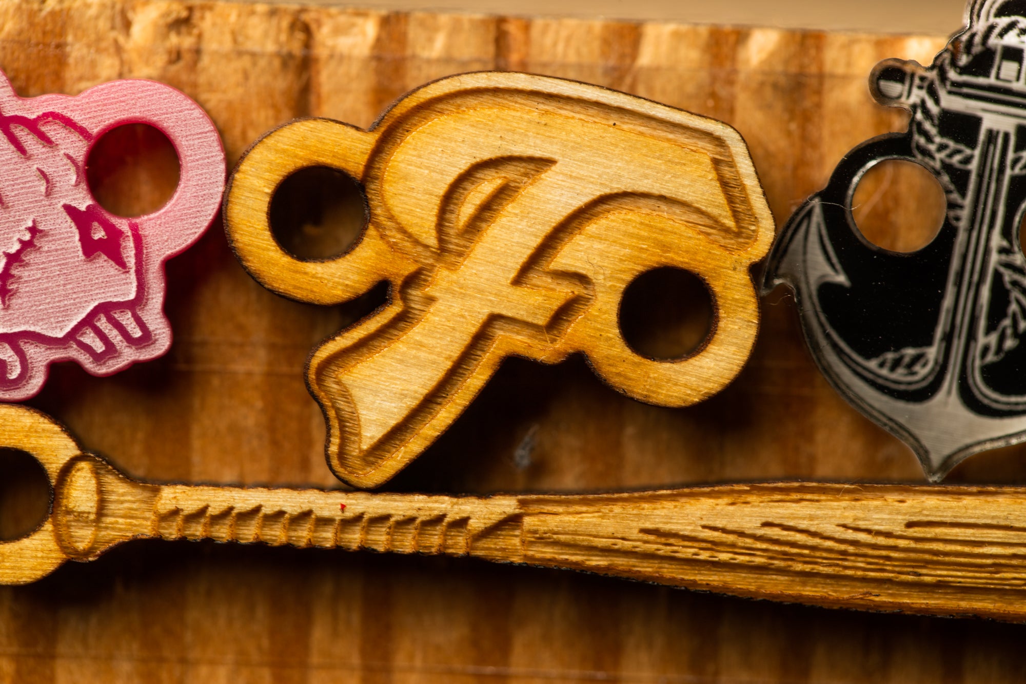 a wooden bat with a logo on it, along with other wooden objects.