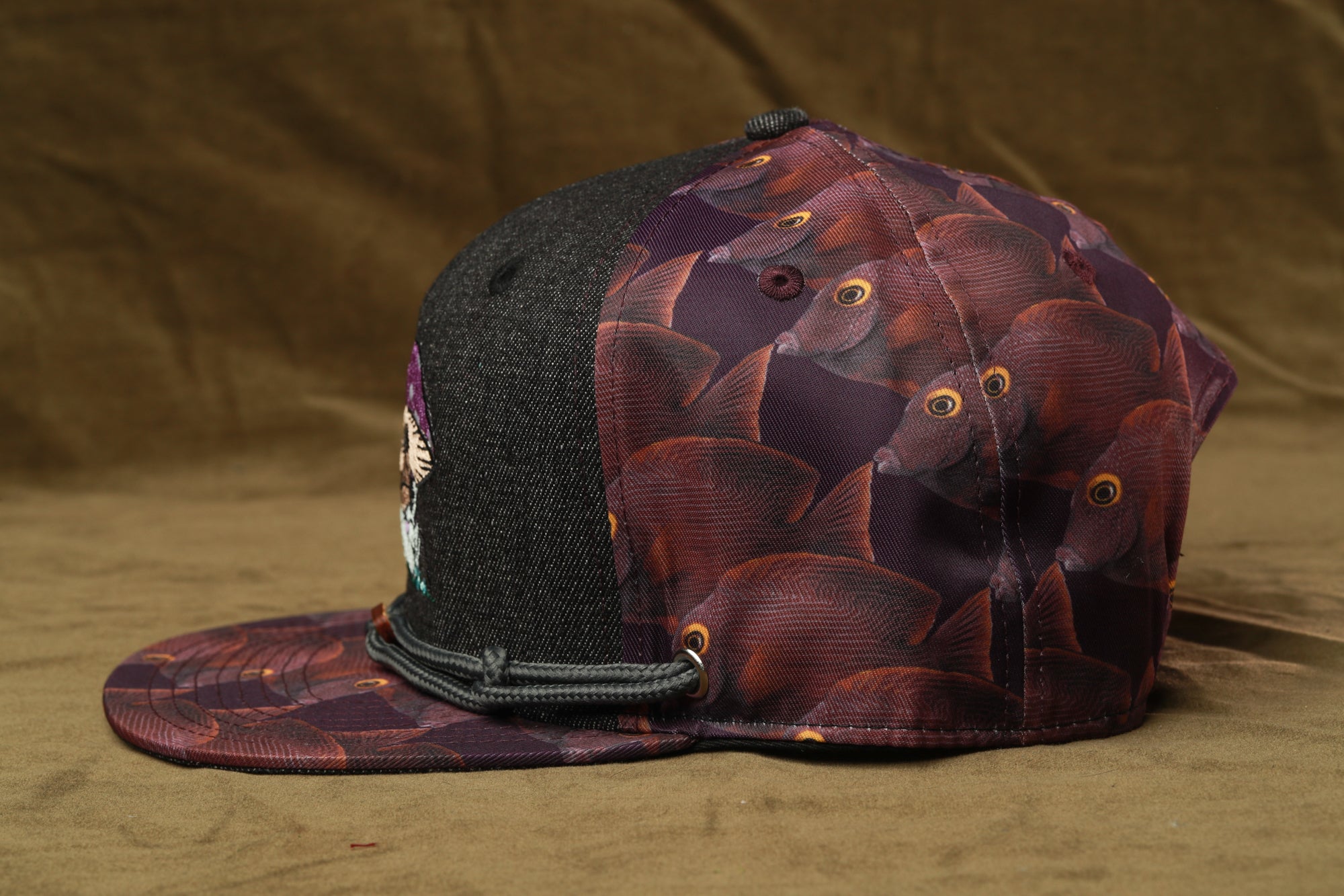 A baseball cap with a fish print pattern on the front and back.