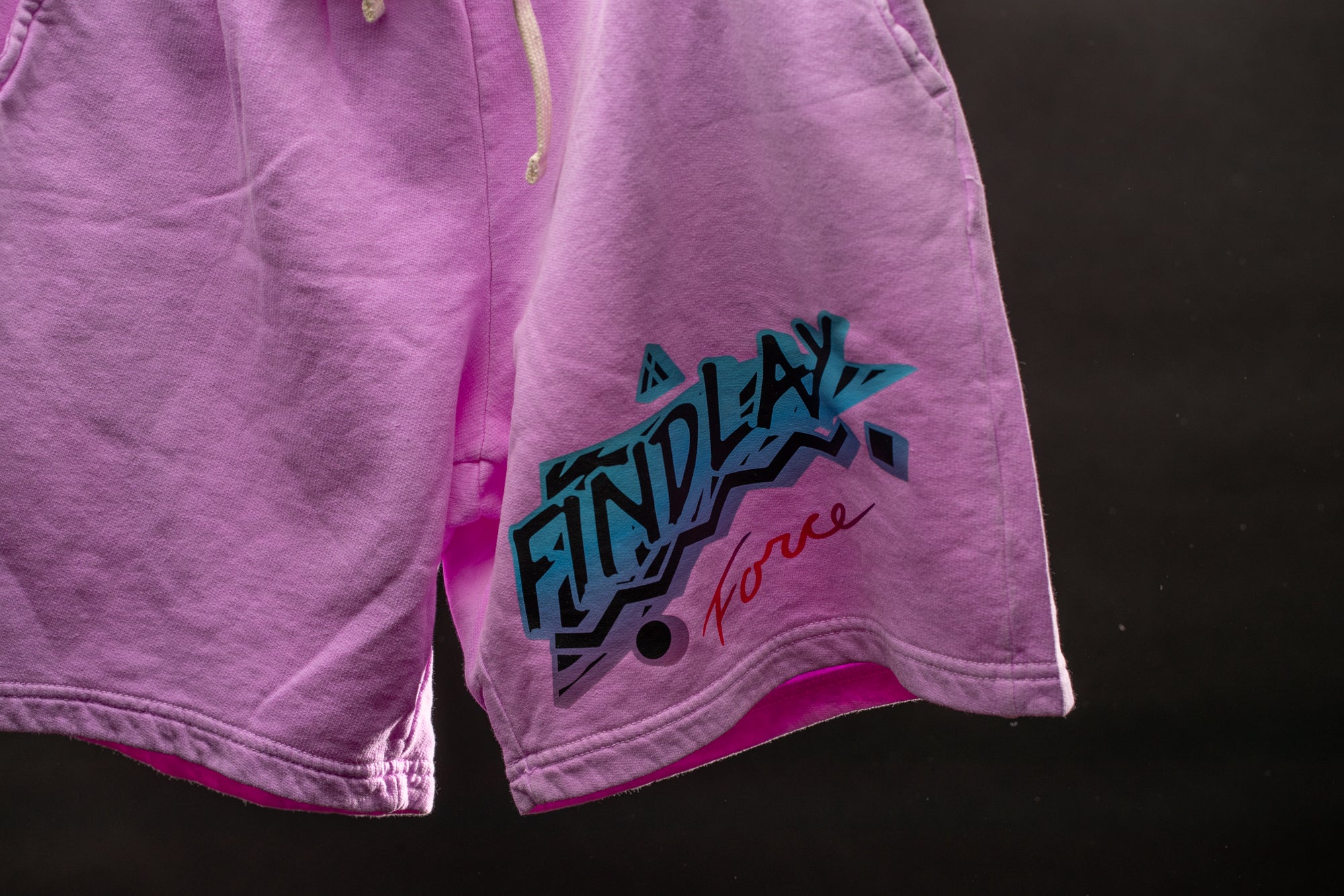 a pair of pink shorts hanging on a clothes line