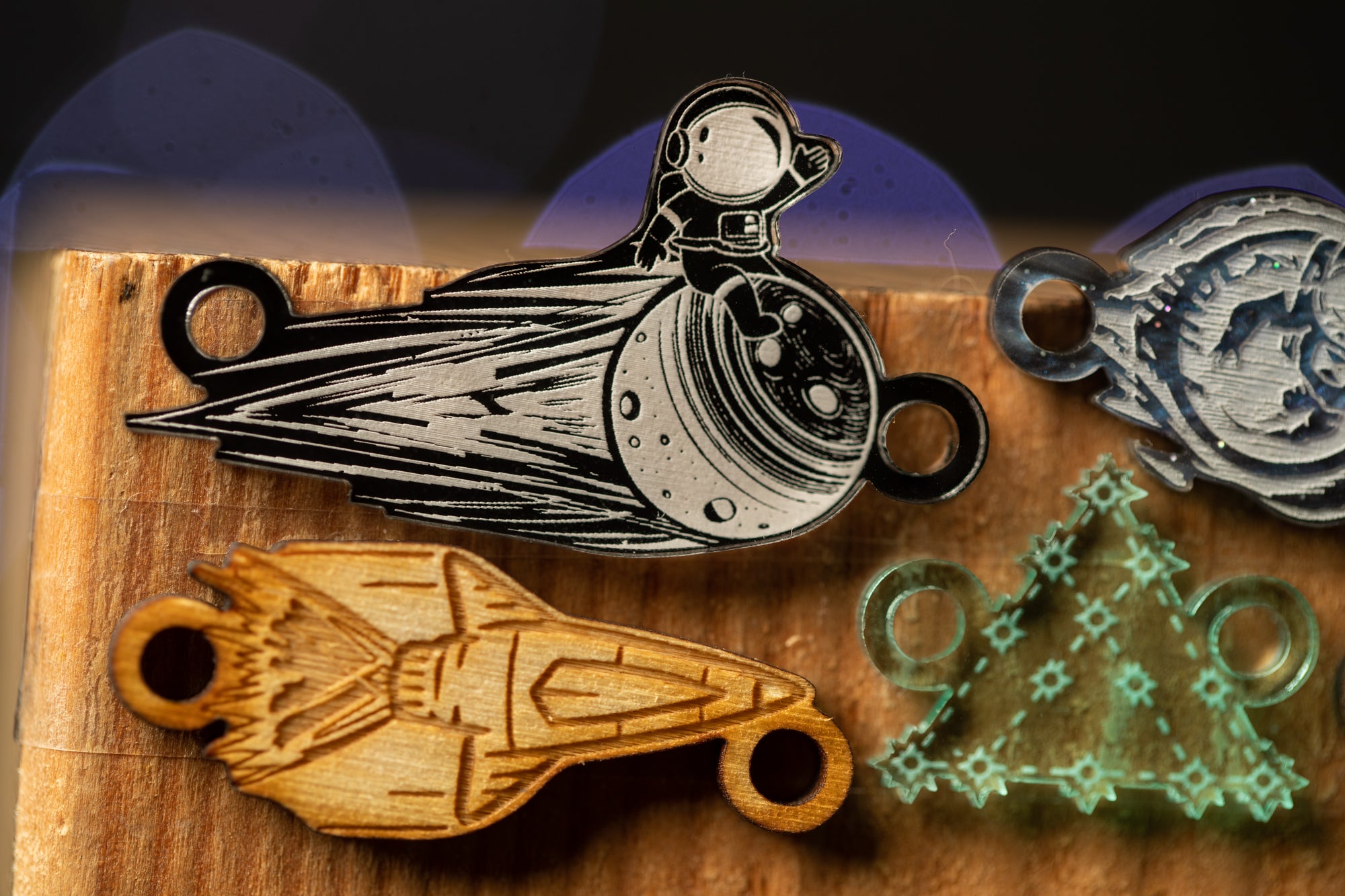 a wooden object with a space-themed design, including a rocket ship and a space suit, as well as other space-related objects.