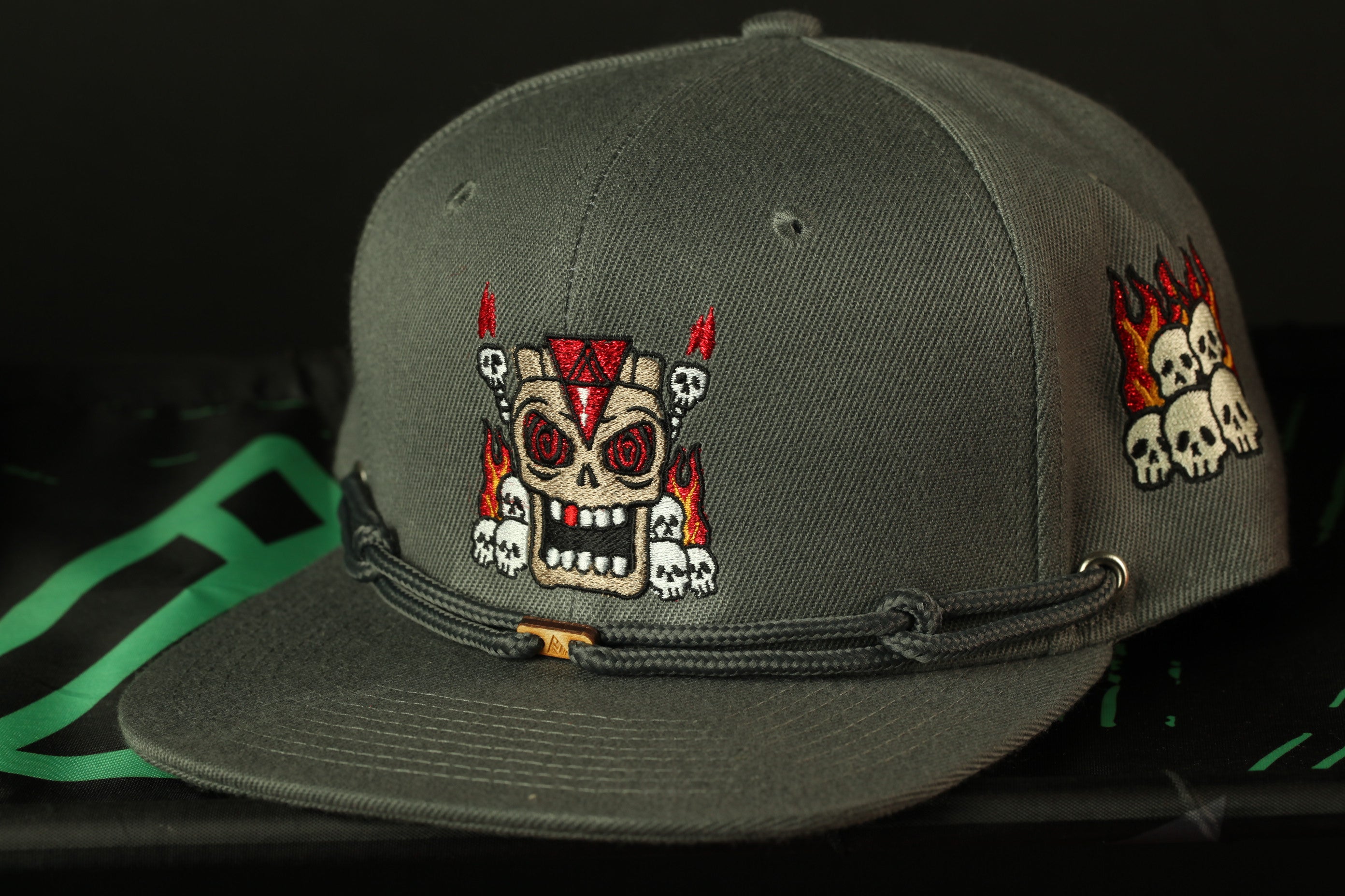 A gray baseball cap with a skull and crossbones design on the front.