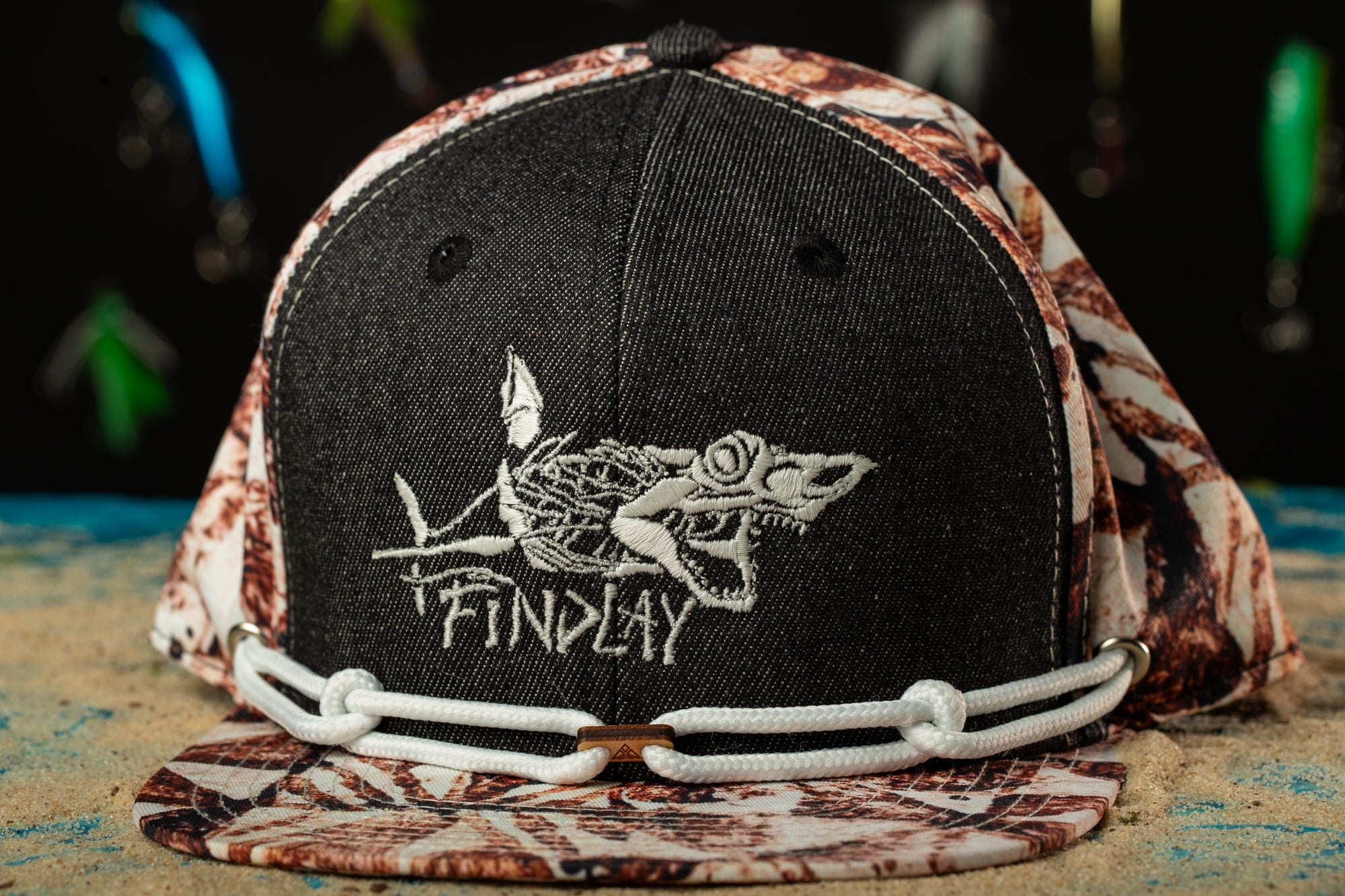 a black and white hat with a picture of a fish on it