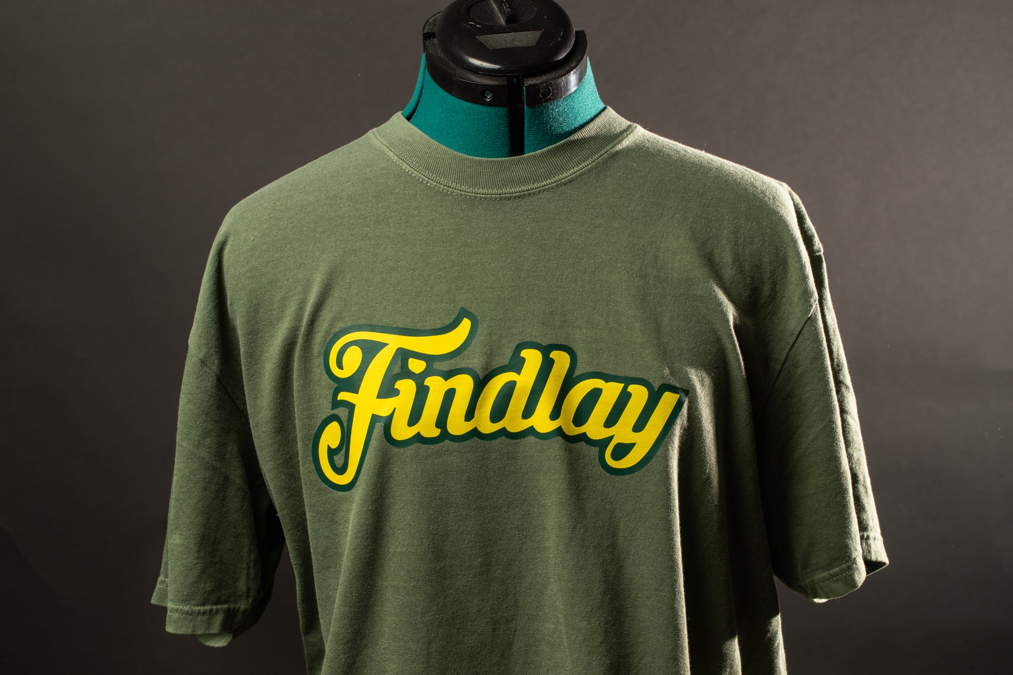 A green t-shirt with yellow text on it, which says "Findlay".