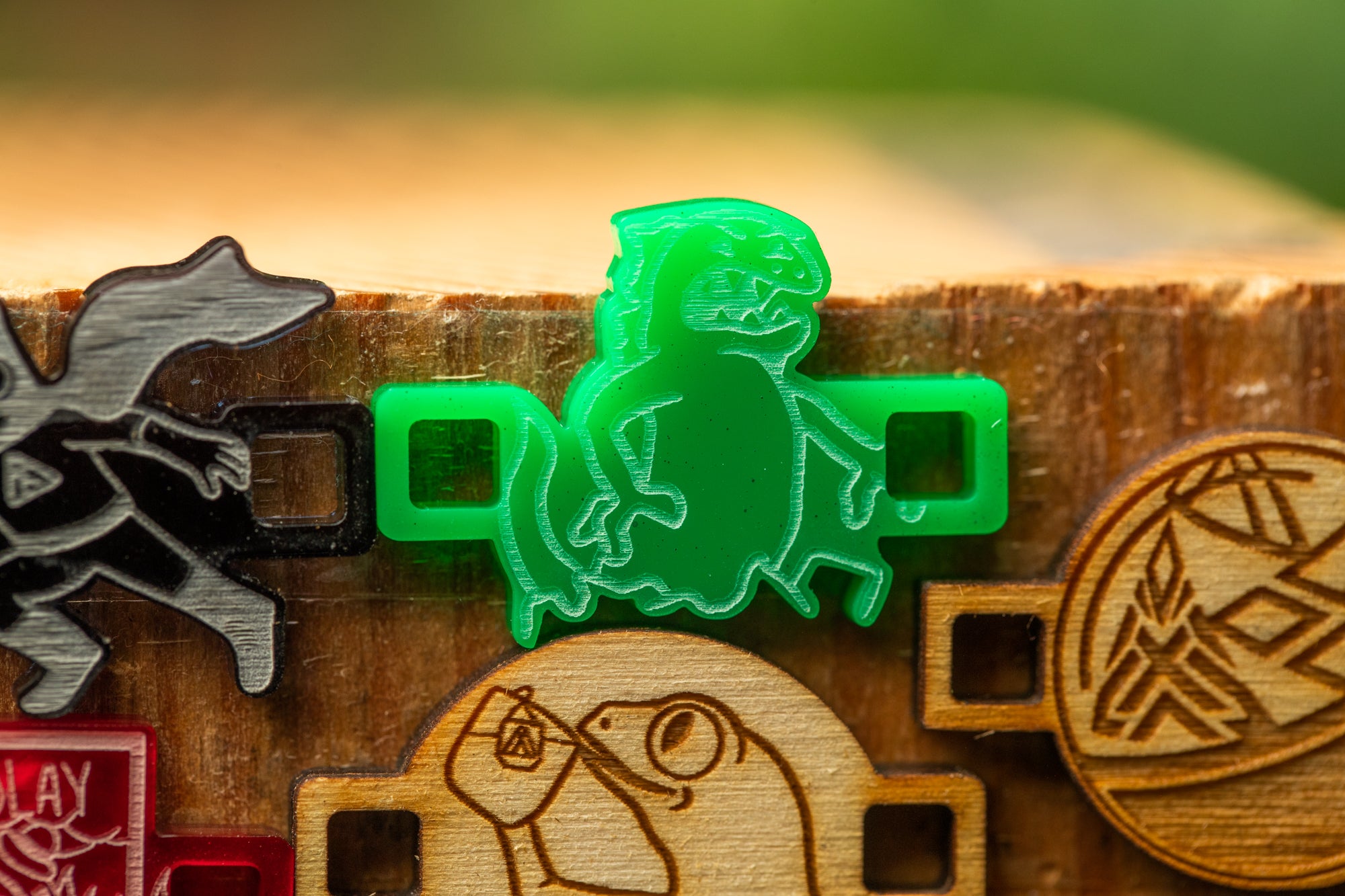 a close-up view of a green plastic object with a cartoon-like design, placed on a wooden surface.