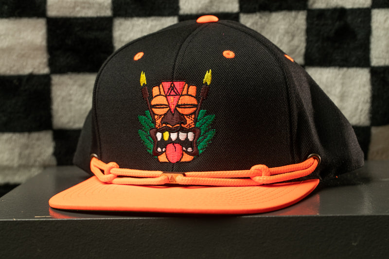 A black baseball cap with an orange brim and a colorful graphic design on the front.
