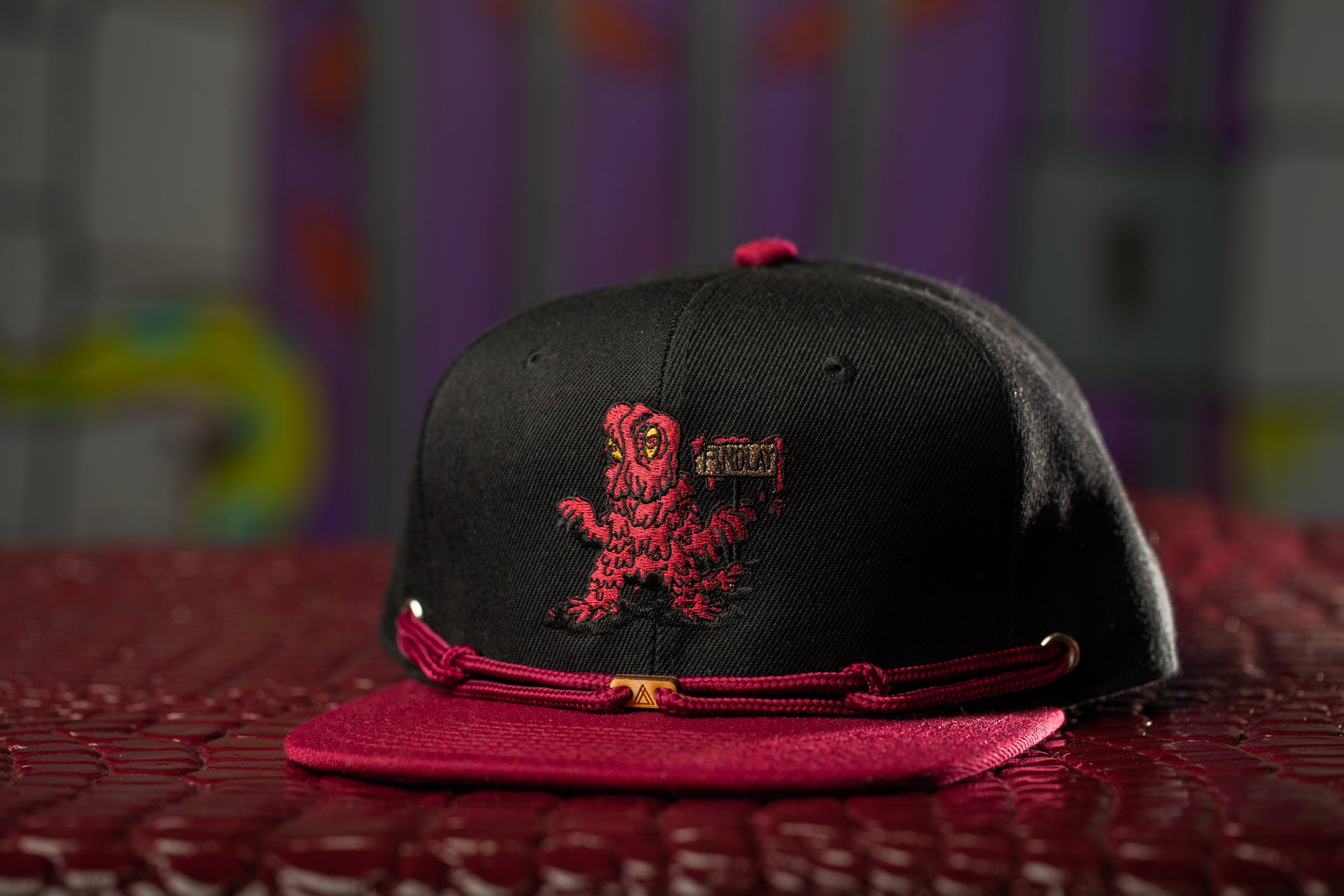 a black and red hat sitting on top of a table