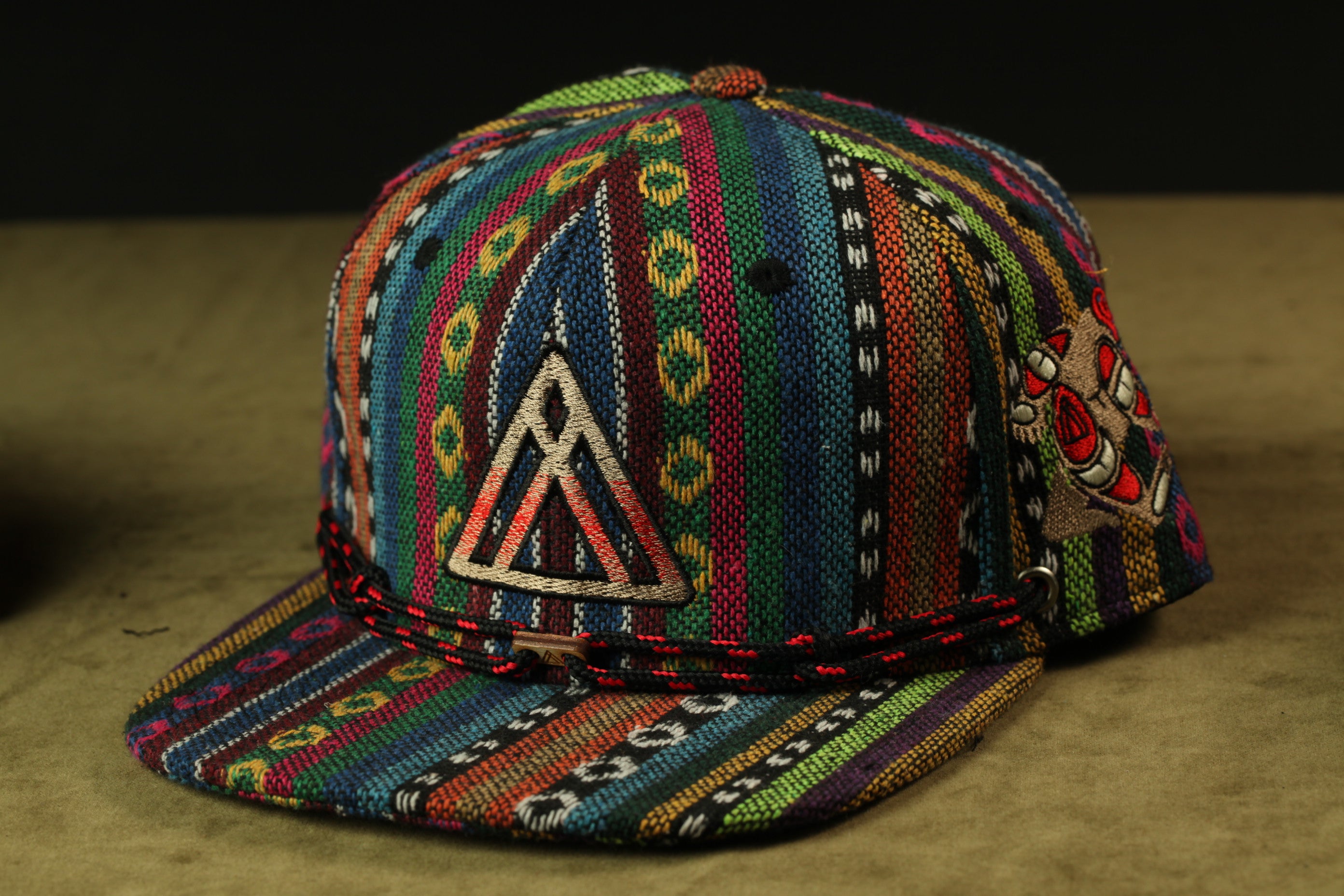 A colorful, patterned baseball cap with a distinctive triangle design on the front.