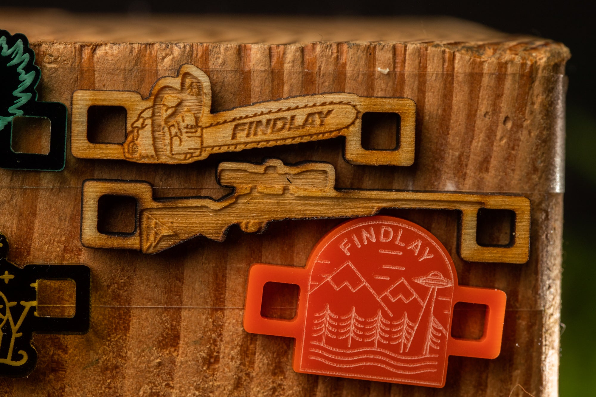 a wooden surface with various wooden objects, including a pair of wooden keys and a wooden arrowhead.