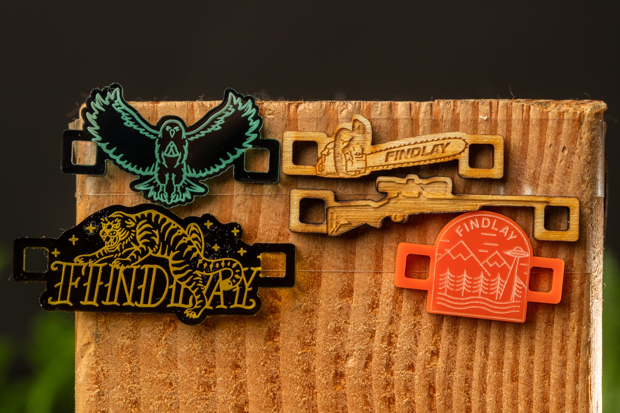 a wooden surface with various colorful and unique wooden objects, including a bird, a chainsaw, and a red and orange object.