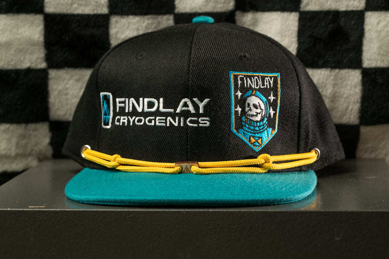 A black baseball cap with teal brim and yellow strings, featuring a logo and a skull design.