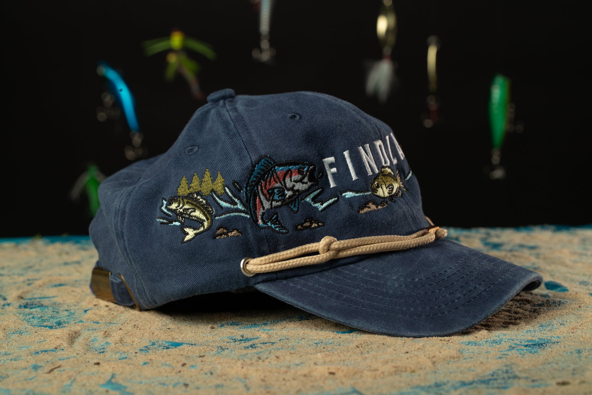 a blue hat with a fish hook on it