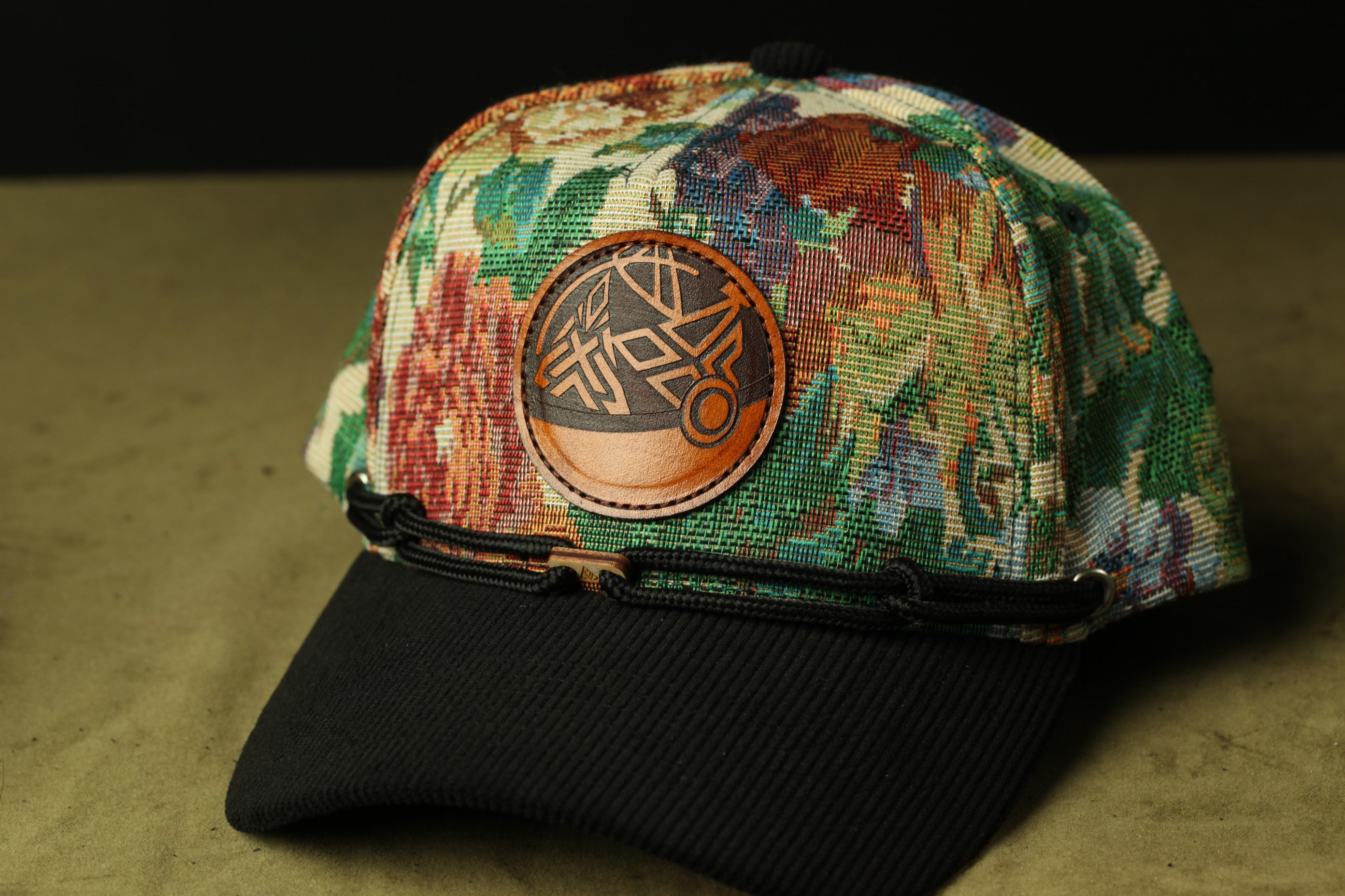 A colorful, patterned baseball cap with a circular patch on the front.