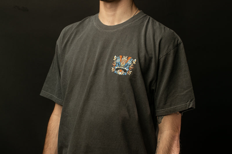 A person wearing a gray t-shirt with a colorful graphic design on the front.