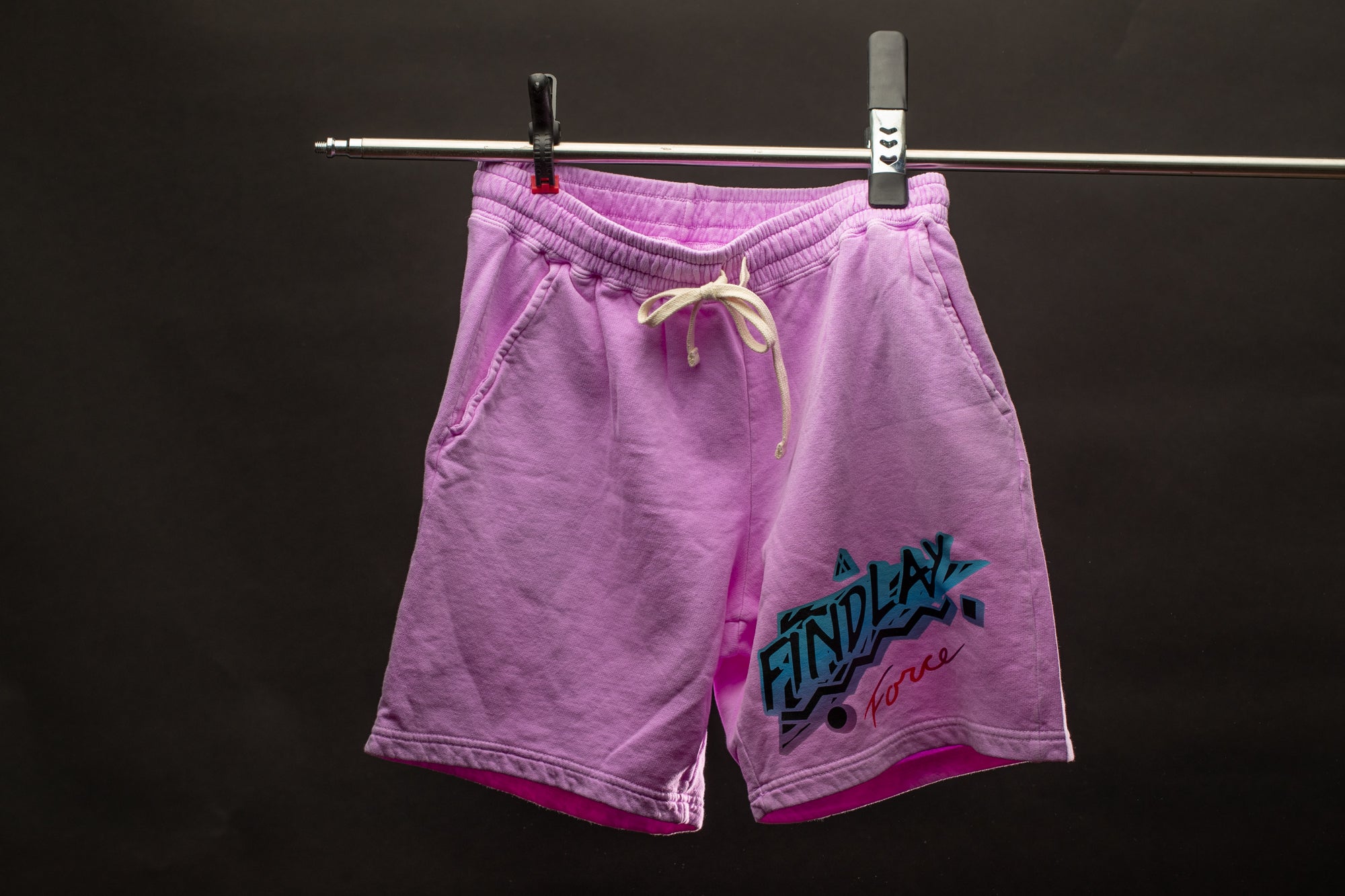 a pair of pink shorts hanging on a clothes line