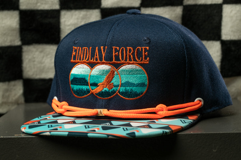 A navy blue baseball cap with a colorful pattern and the text "Findlay Force" printed on it.