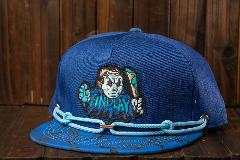 A blue baseball cap with a cartoon character design and a chain strap.
