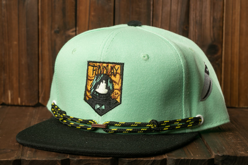 A mint green baseball cap with a black brim and a black and yellow lanyard.