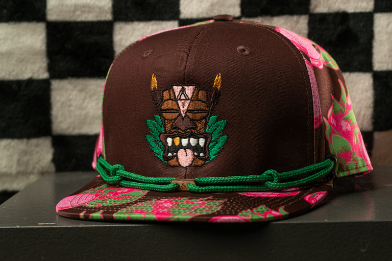 A brown baseball cap with a colorful floral pattern and a graphic design on the front.