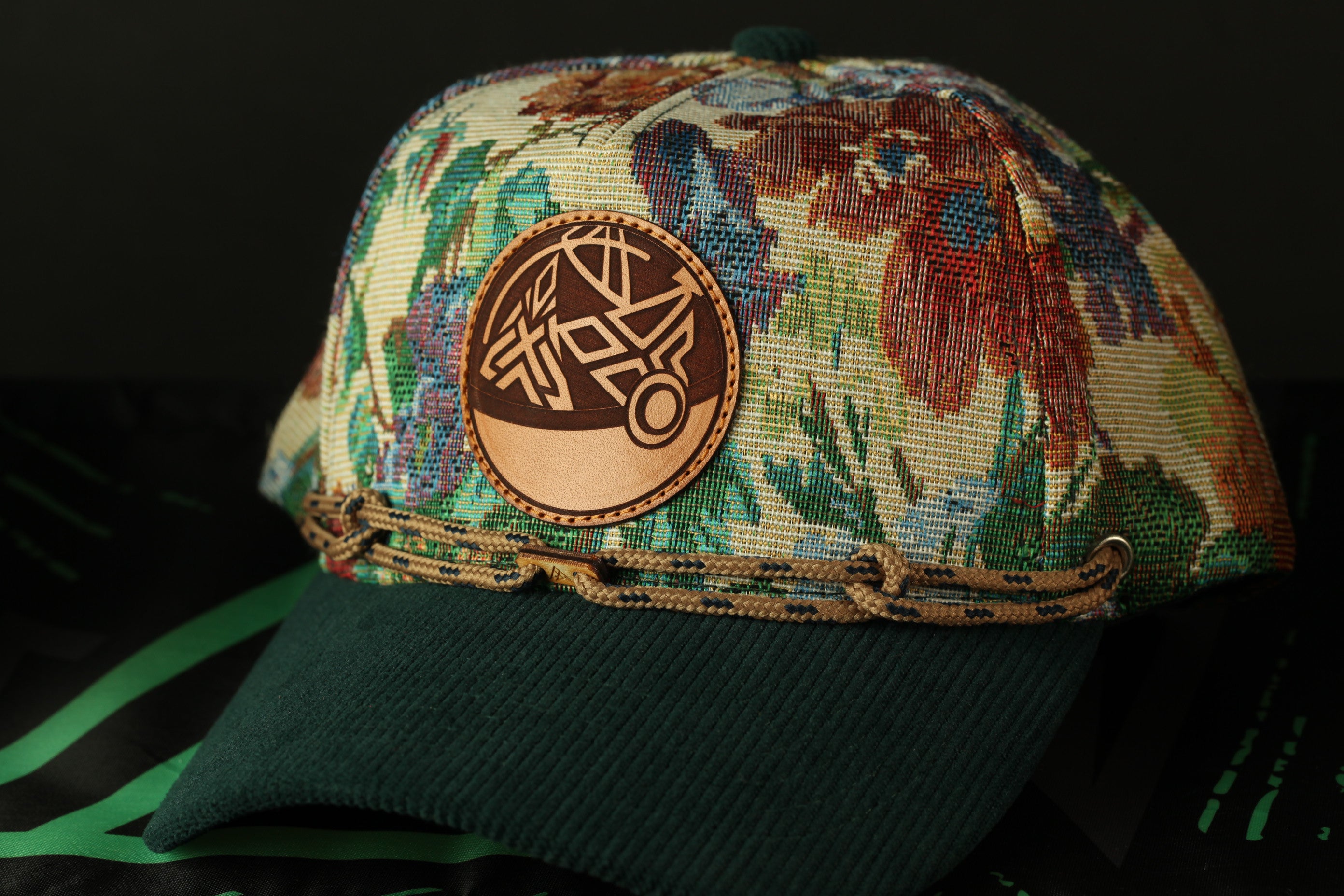 A colorful floral-patterned baseball cap with a circular patch on the front.