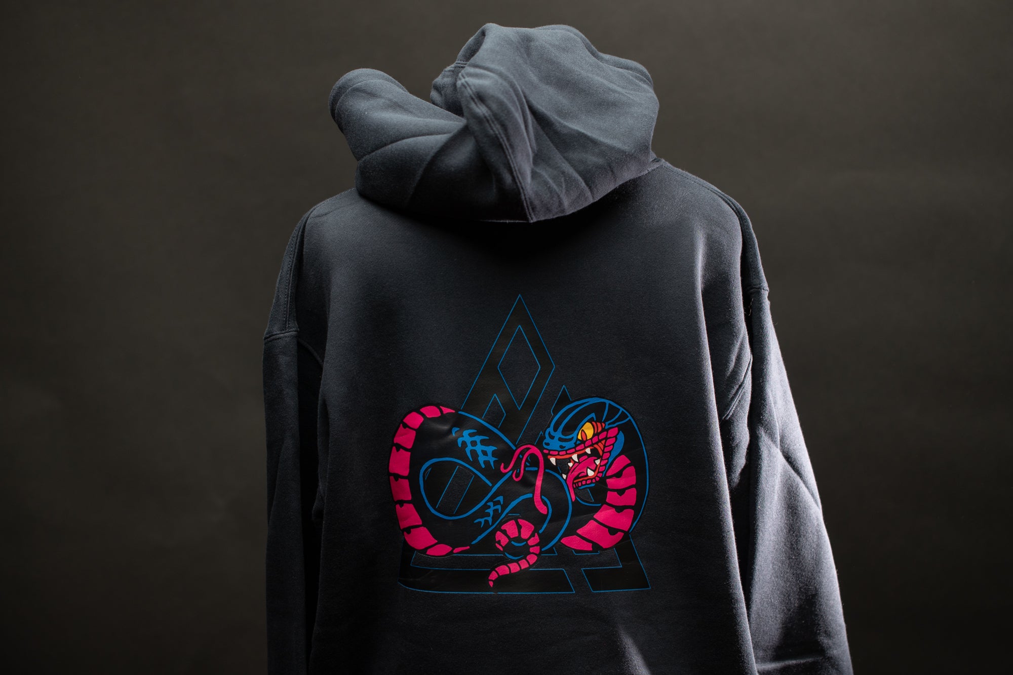 a person wearing a hoodie with a dragon on it