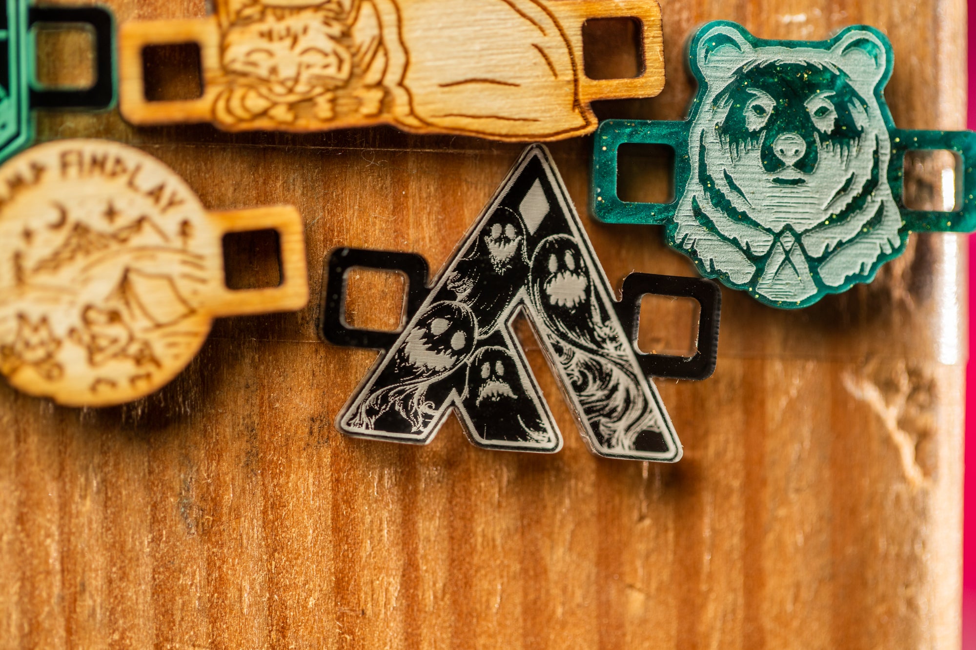 a wooden surface with various objects, including a bear head, a black and white skull design, and other miscellaneous items.