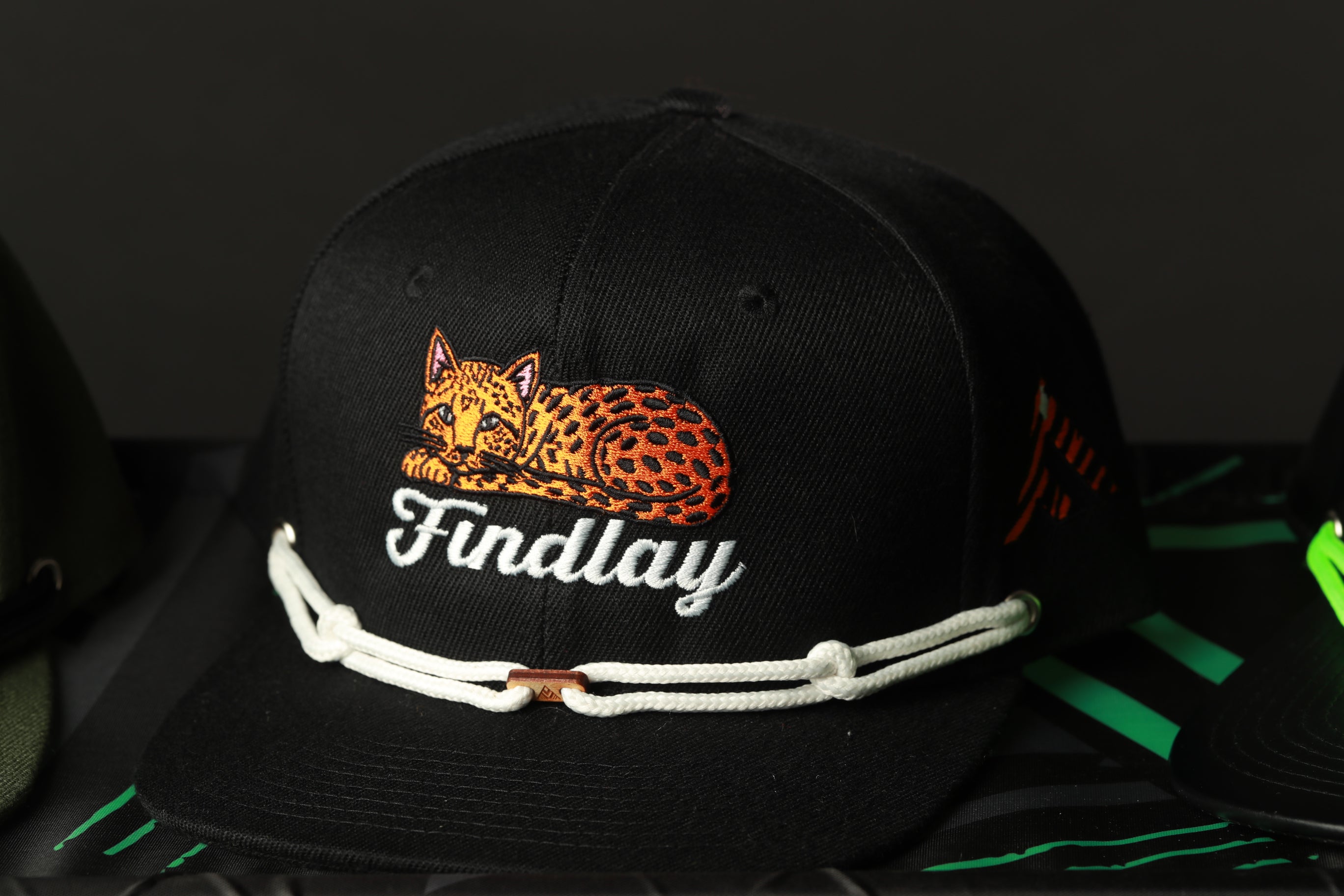 A black baseball cap with a leopard print design and the word "Findlay" printed on it.