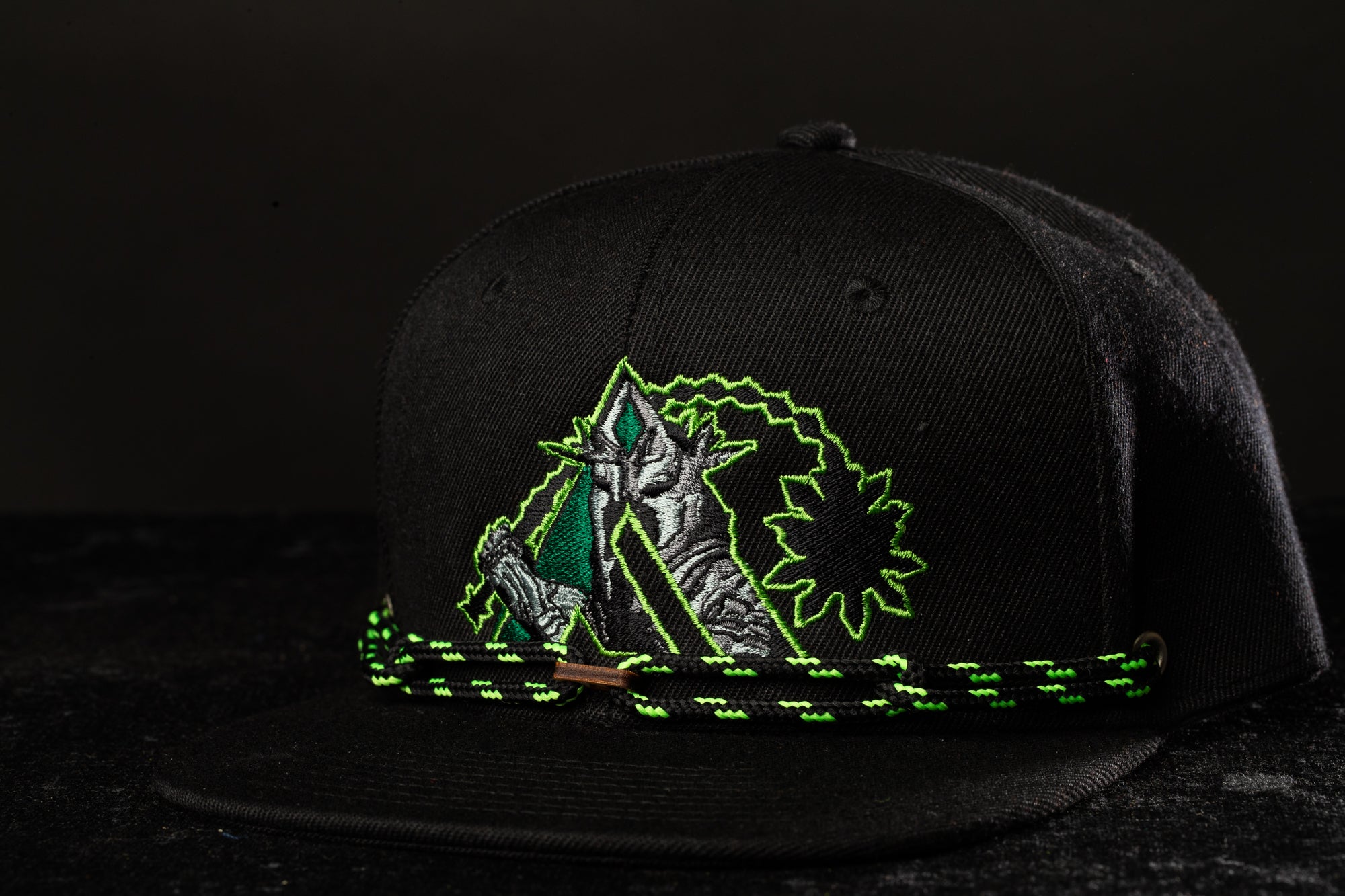 a green and black hat with a picture of a person on it